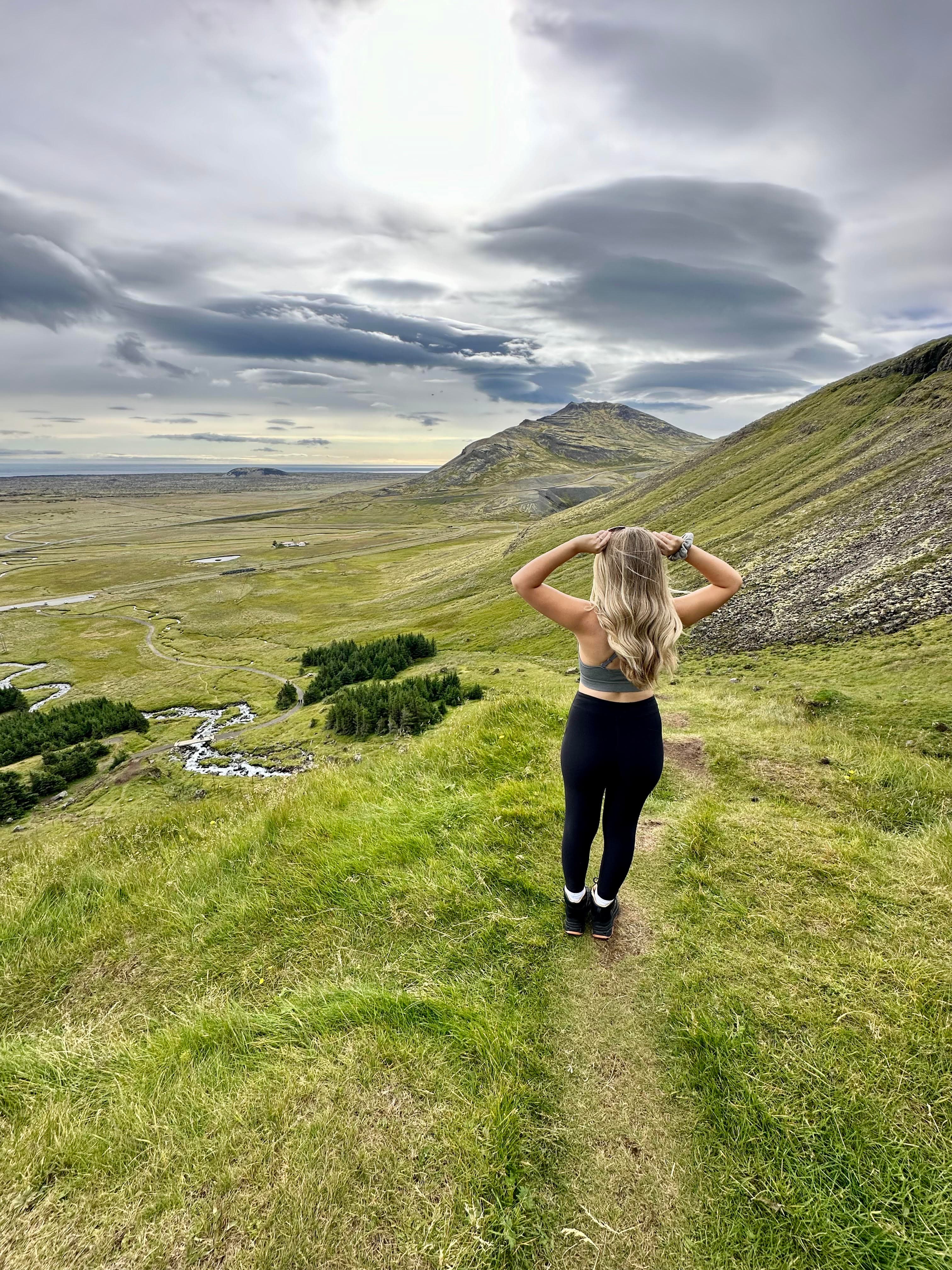 Advisor on a hike through grassy hills on a cloudy day