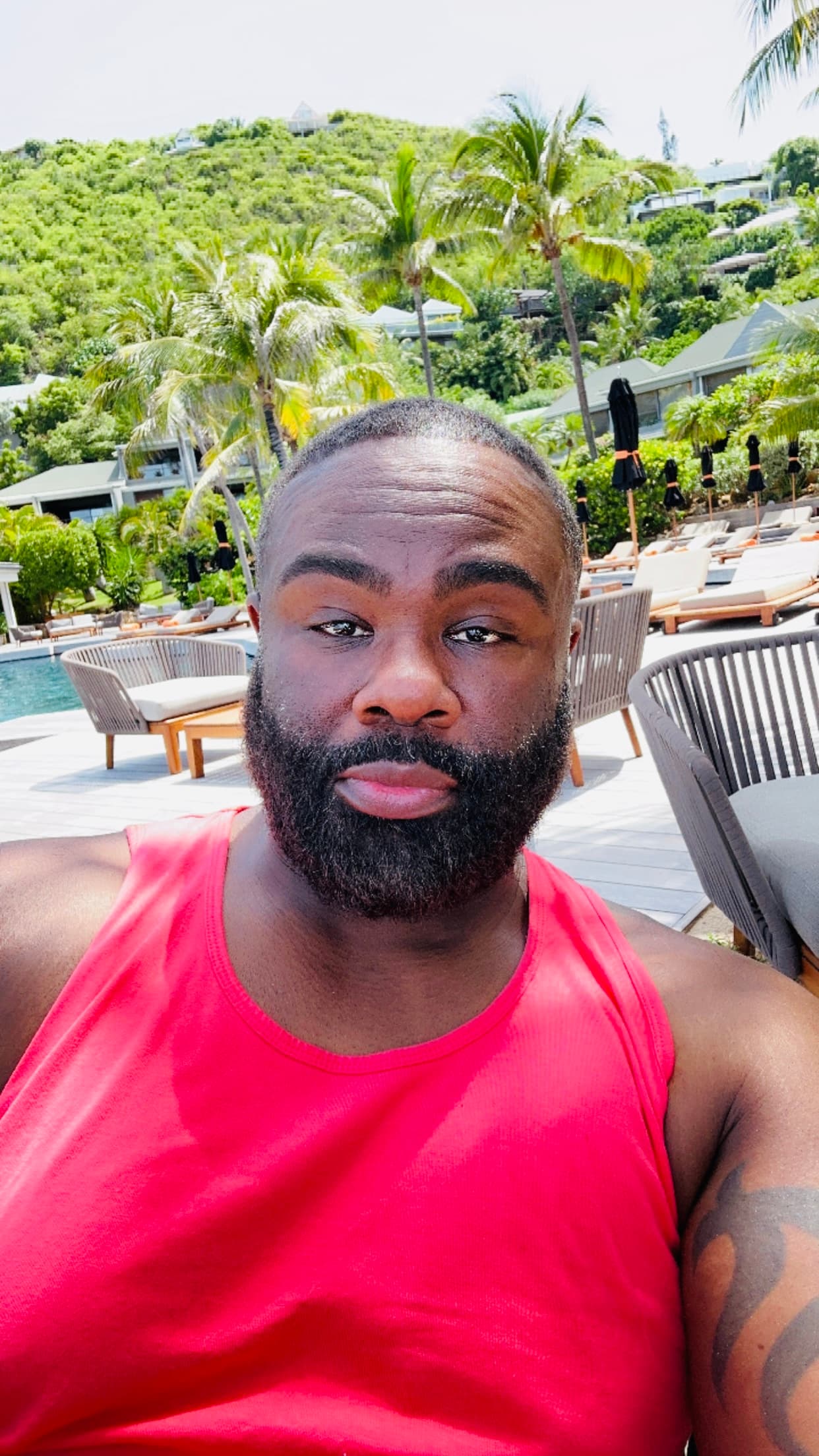 Advisor in a red tank top taking a selfie outdoors on a sunny day