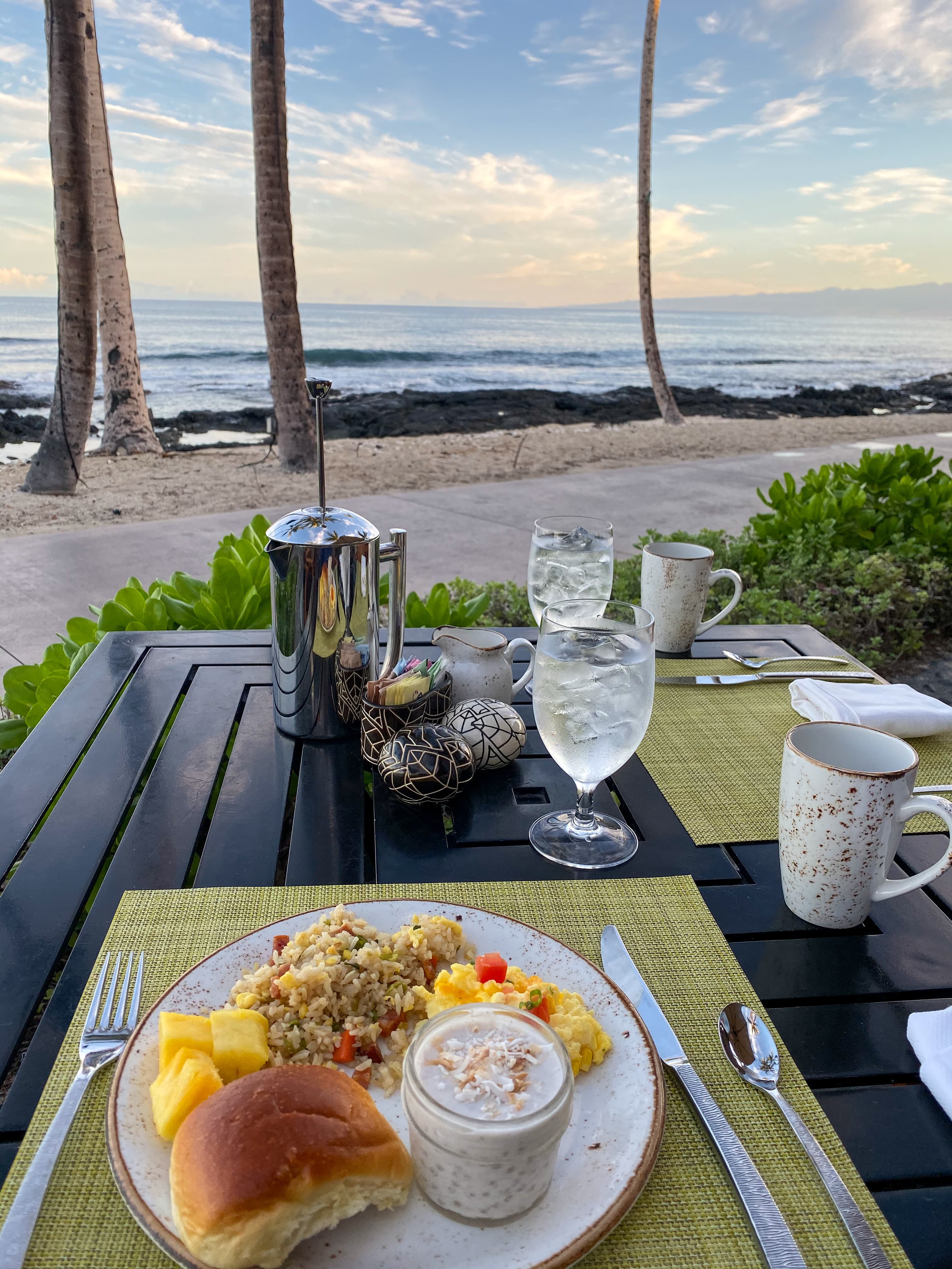 View of a plate of food on an outdoor restaurant table overlooking the sea