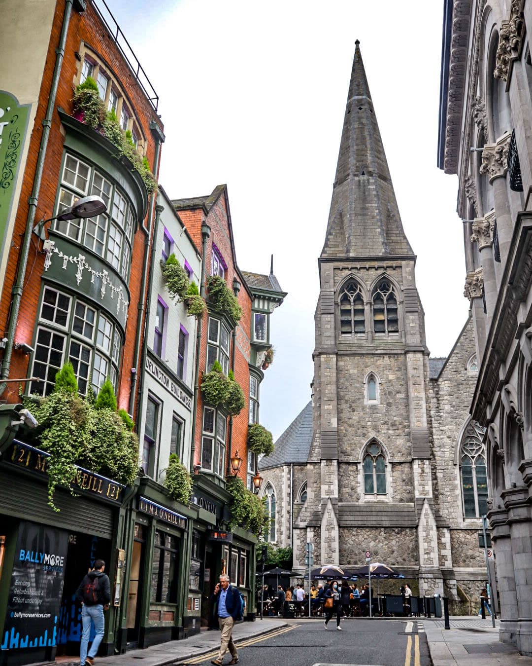 View of an old stone church on a small city street on a cloudy day