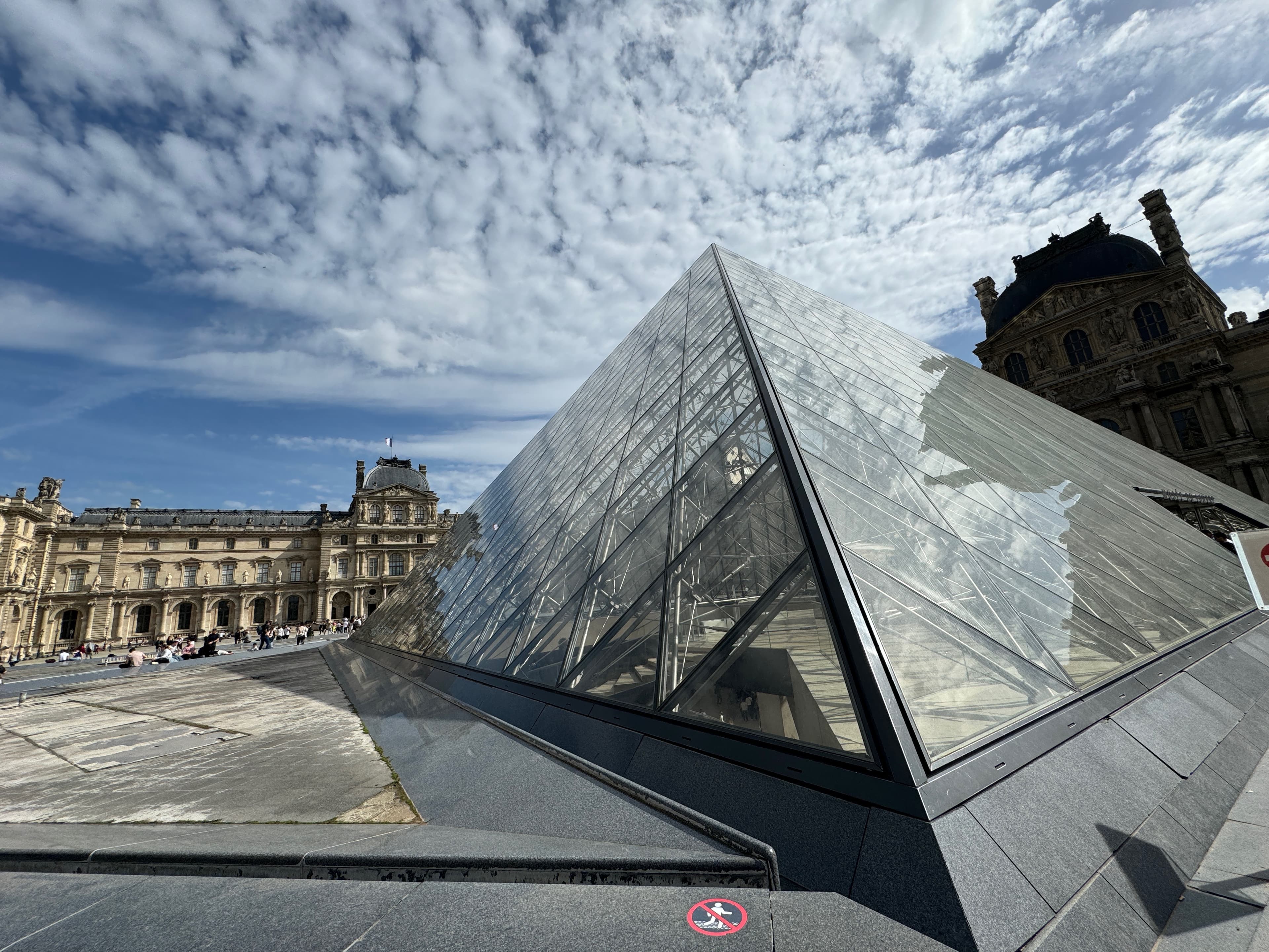 Close up of the Louvre glass pyramid on a sunny day in Paris