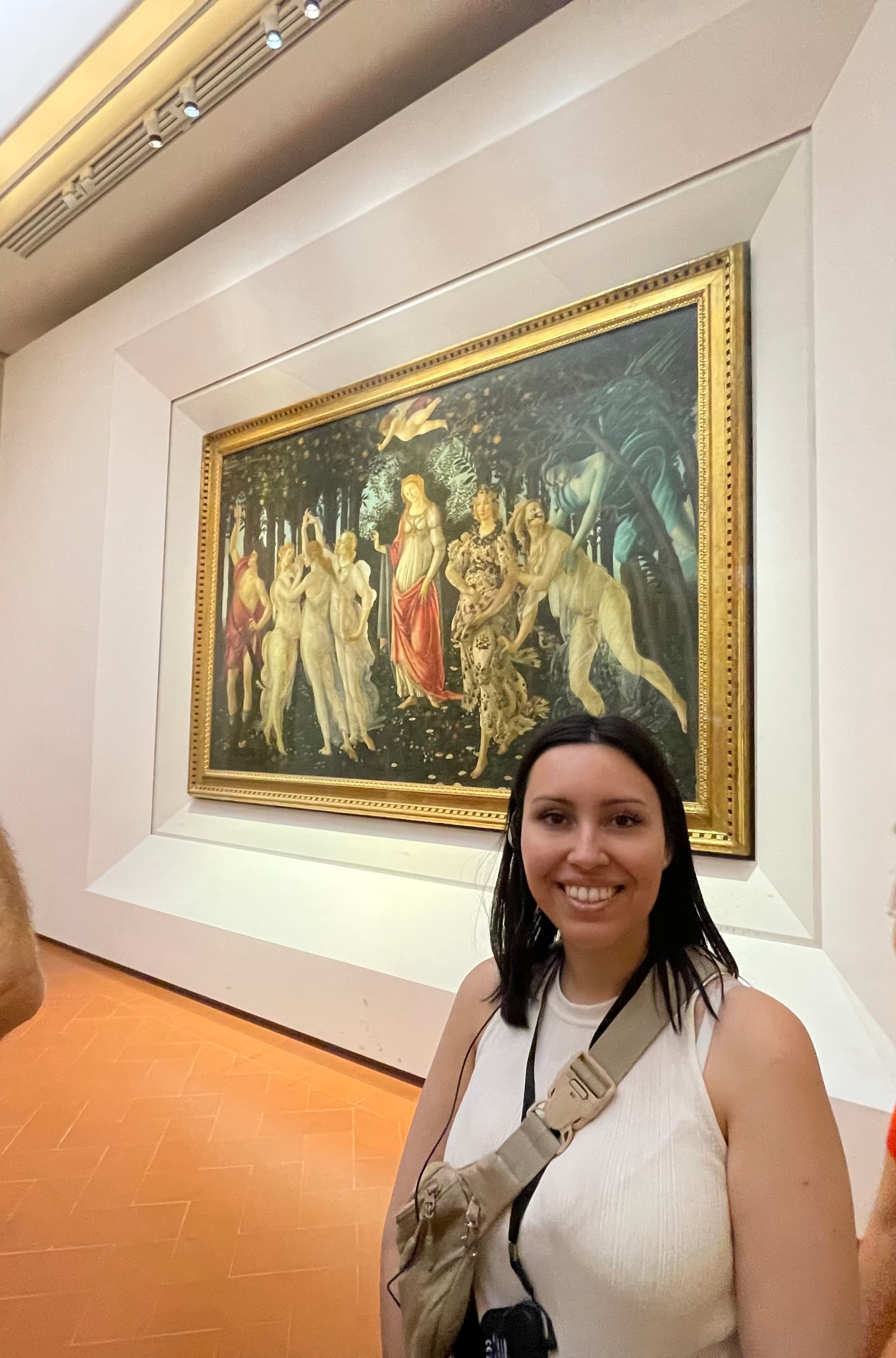 Standing by artwork.