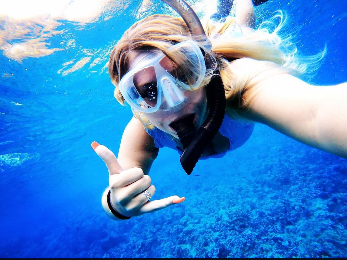 Advisor taking a selfie underwater in snorkeling goggles