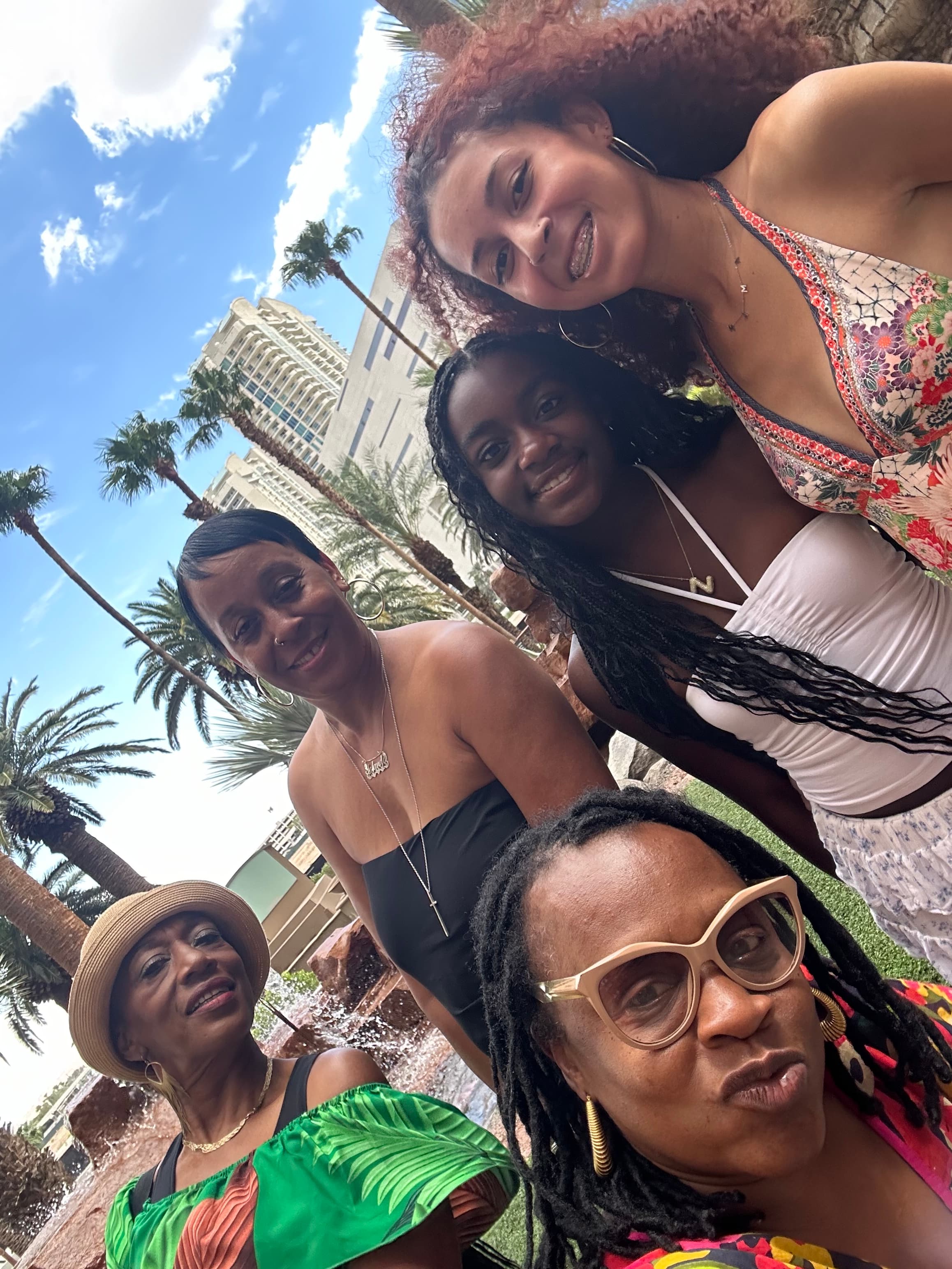 Advisor and friends taking a selfie at a tropical resort on a sunny day
