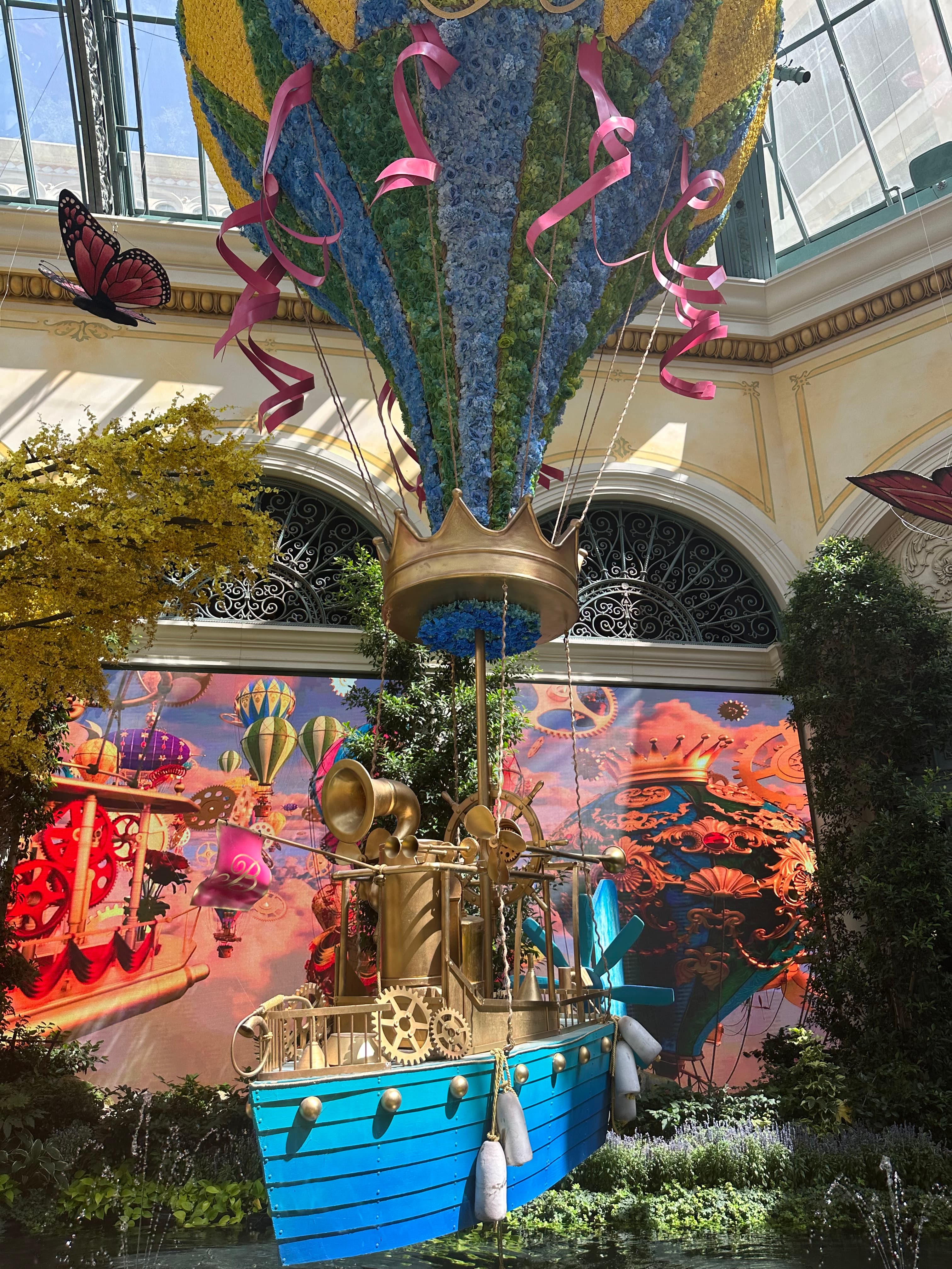 View of an indoor structure of a hot air balloon rising from a blue ship