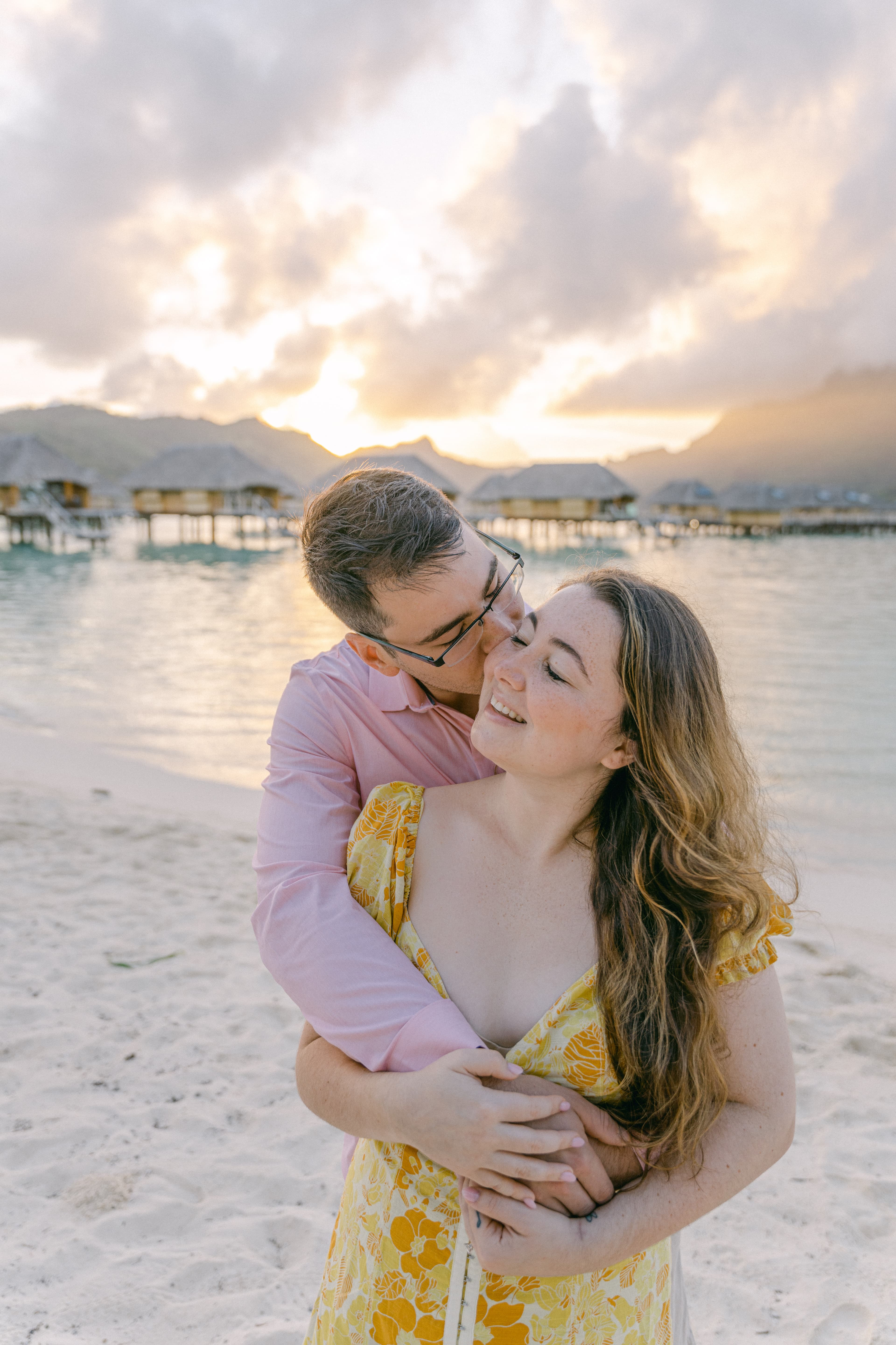 Advisor and partner smiling together on a beautiful beach at sunset