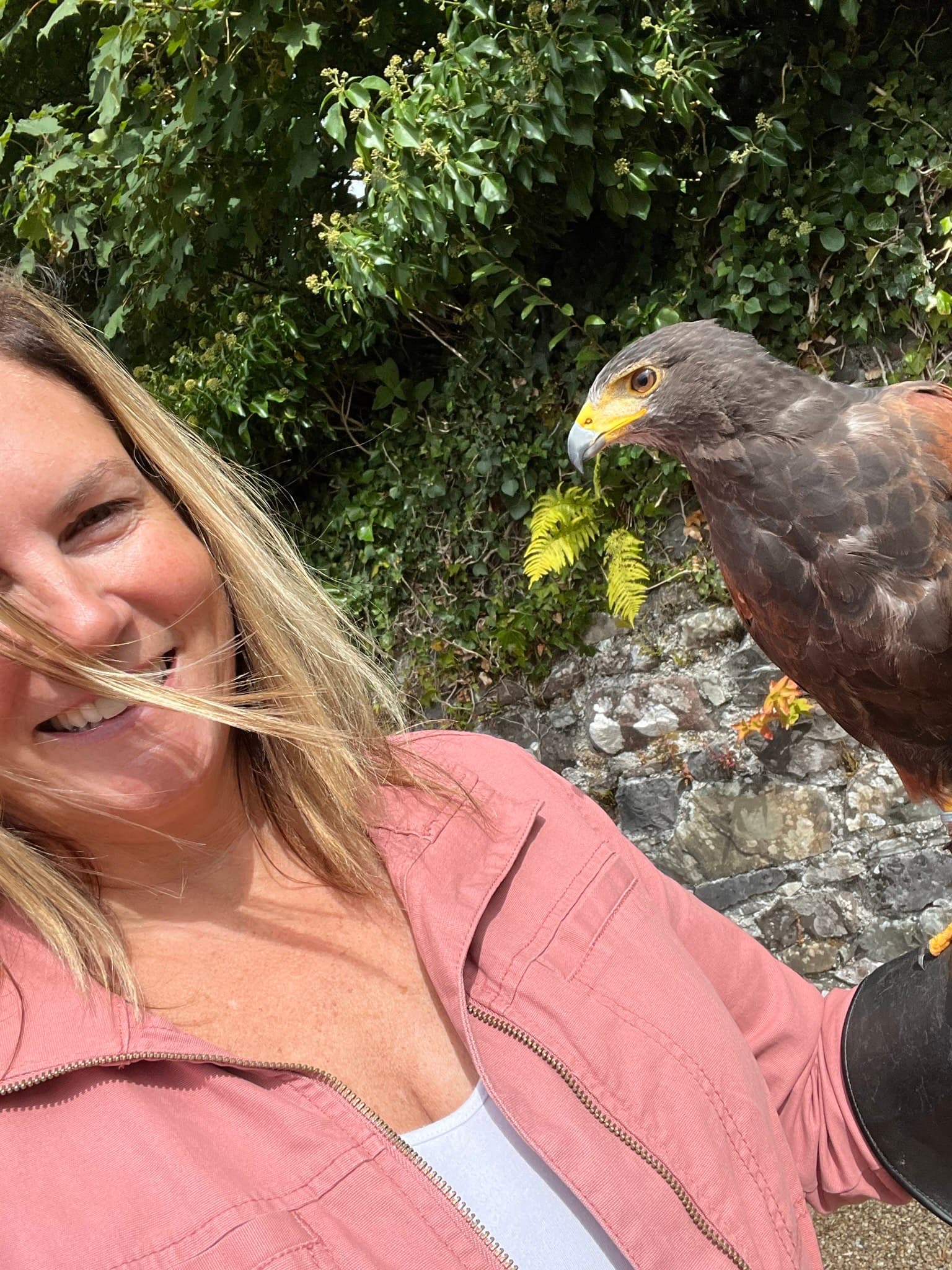 Jayme posing next to a bird outdoors during the daytime.