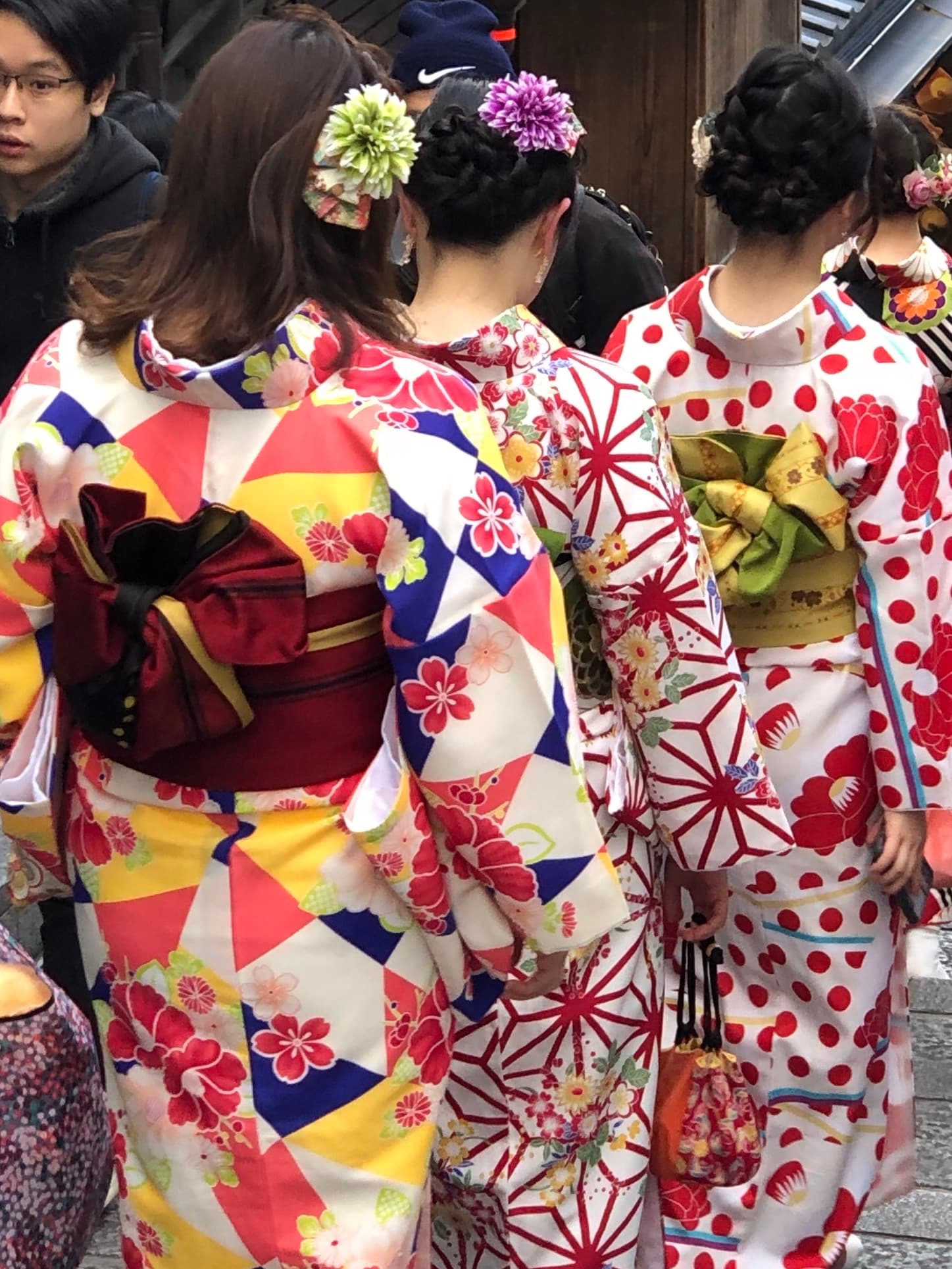 View of the back of colorful women’s outfits in Japan