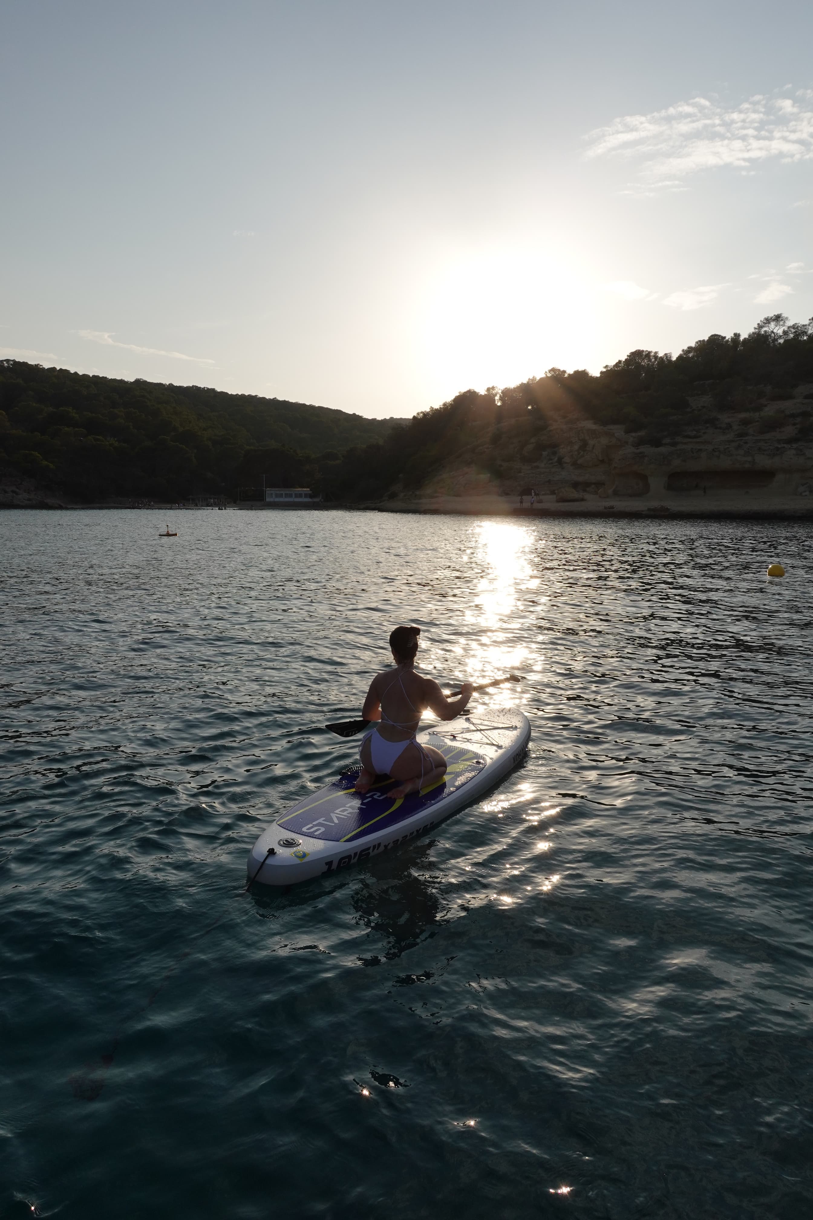 Advisor on a paddleboard on a lake at sunset
