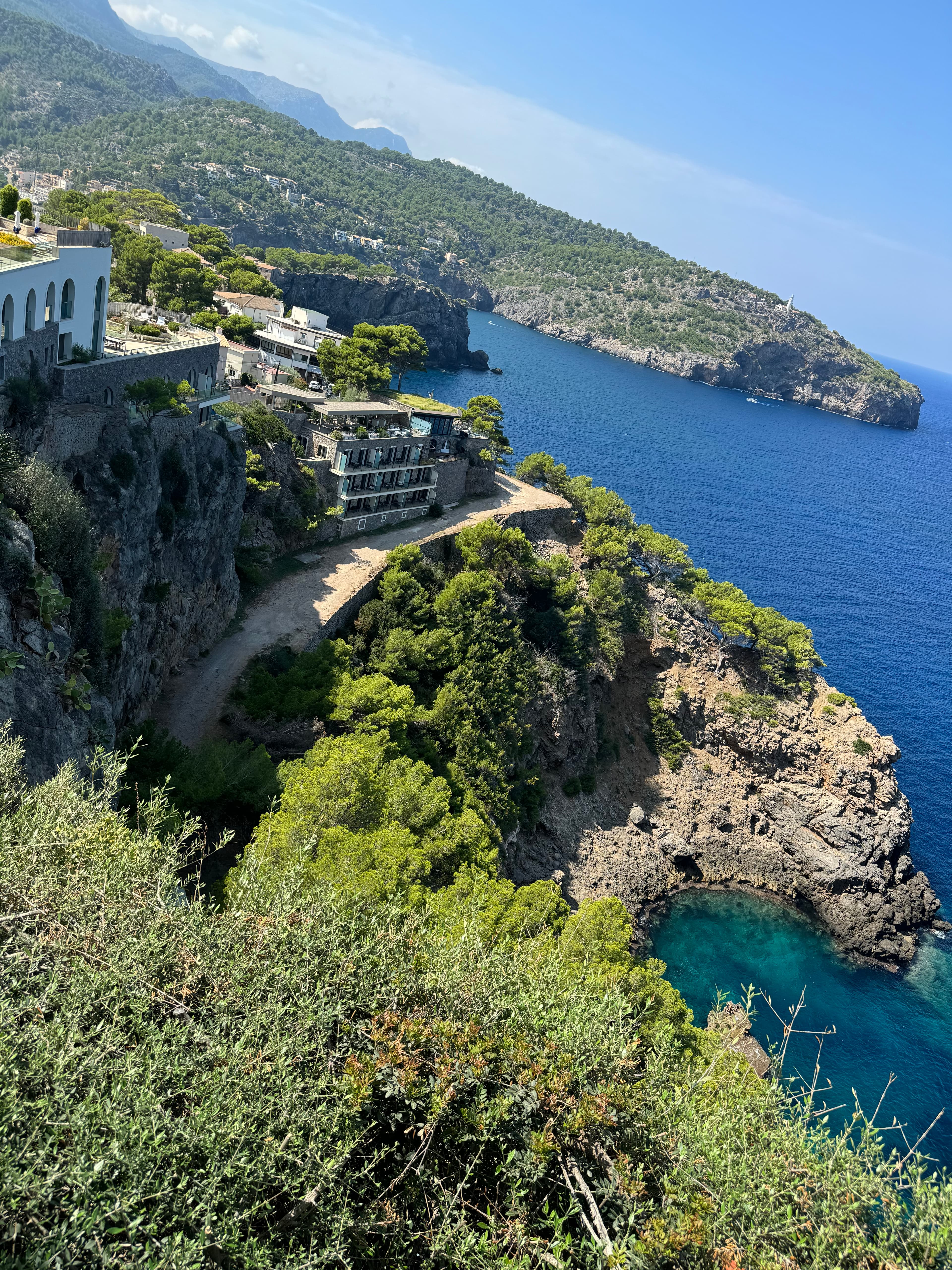 Aerial view of a beautiful coastline and deep blue sea on a sunny day