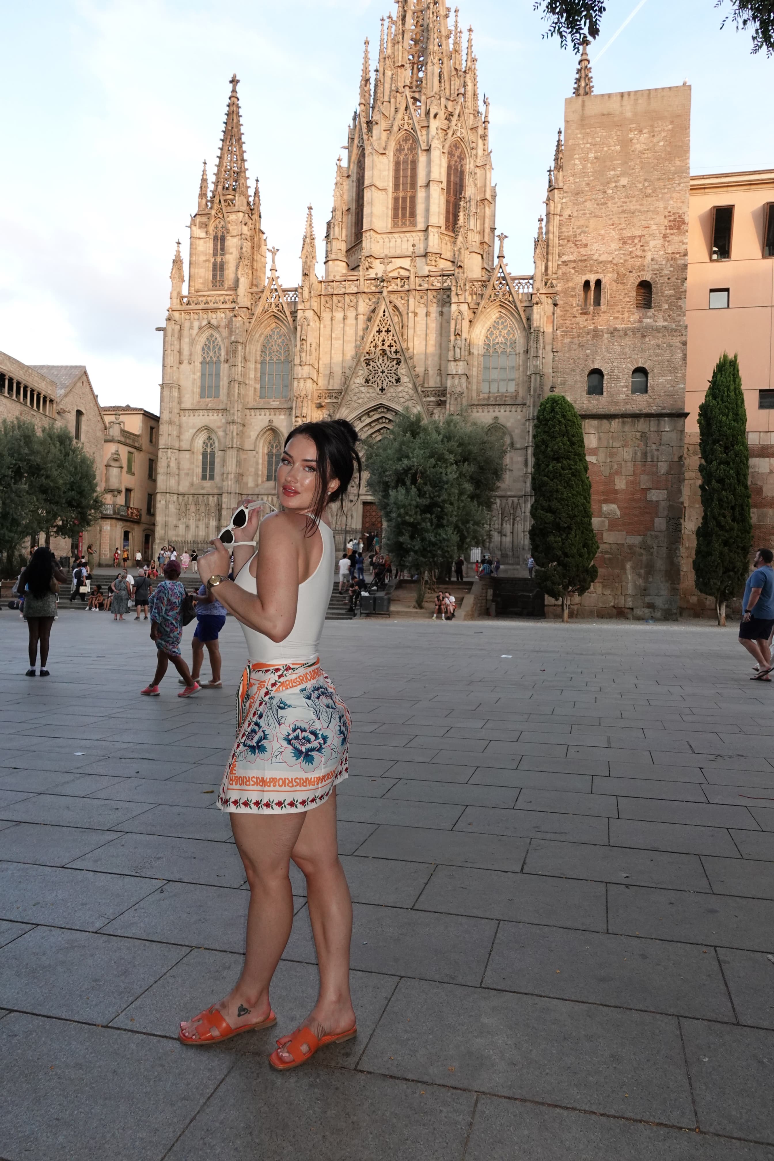 Advisor posing in a city plaza with a beautiful cathedral visible behind her