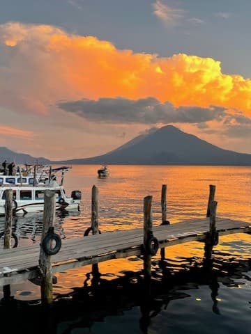 Mountain by the river at sunset.