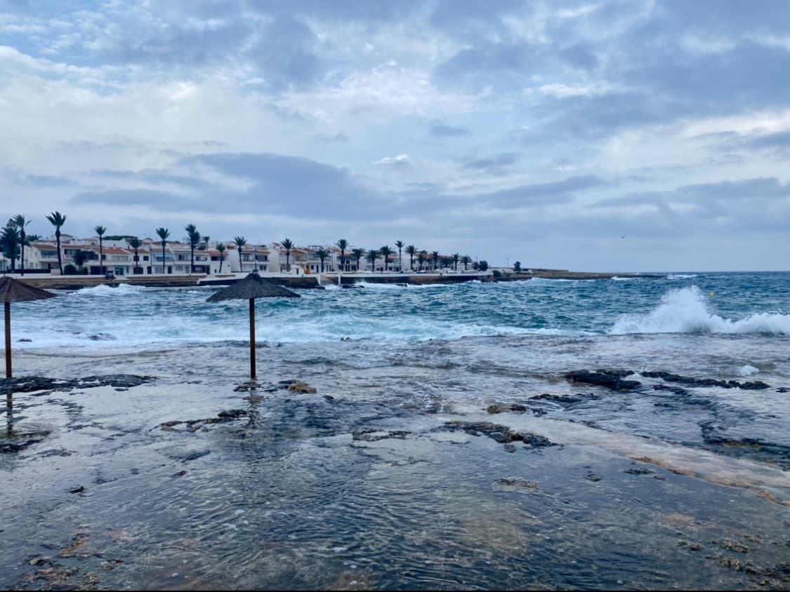 View of a stormy sea with waves crashing on a rocky shore