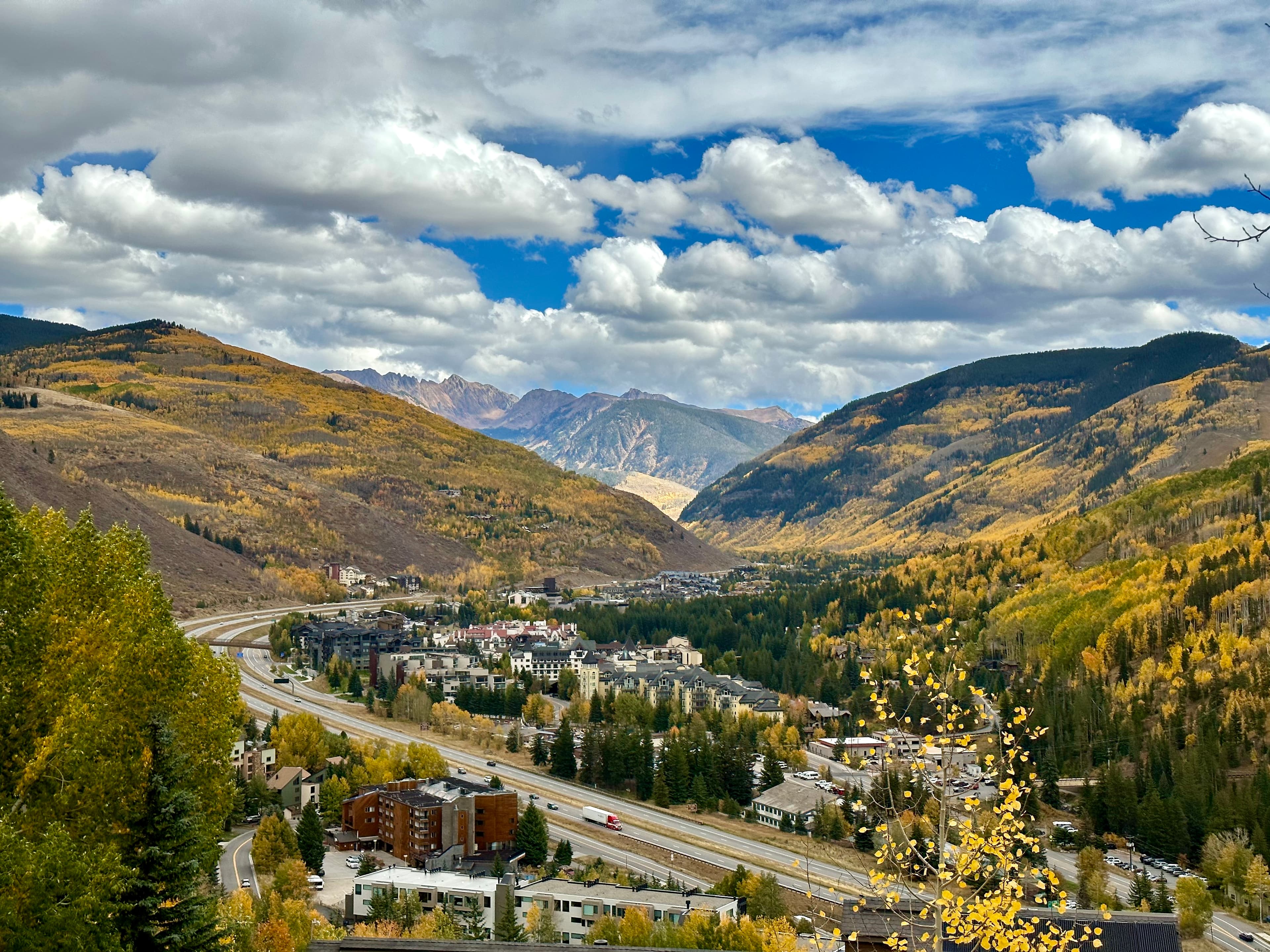 View of a beautiful valley and small town with a mountain range stretching out in the distance