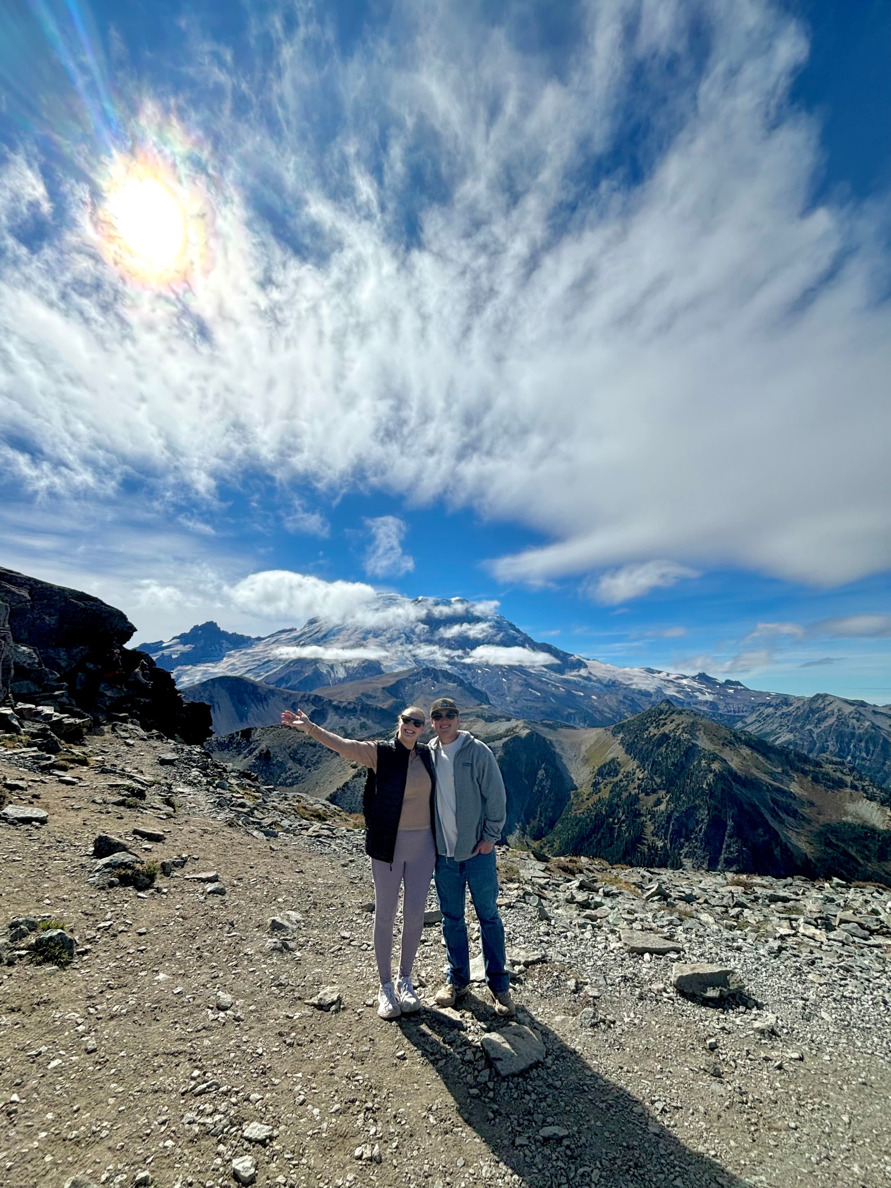 Advisor and partner side by side with a beautiful mountain behind them