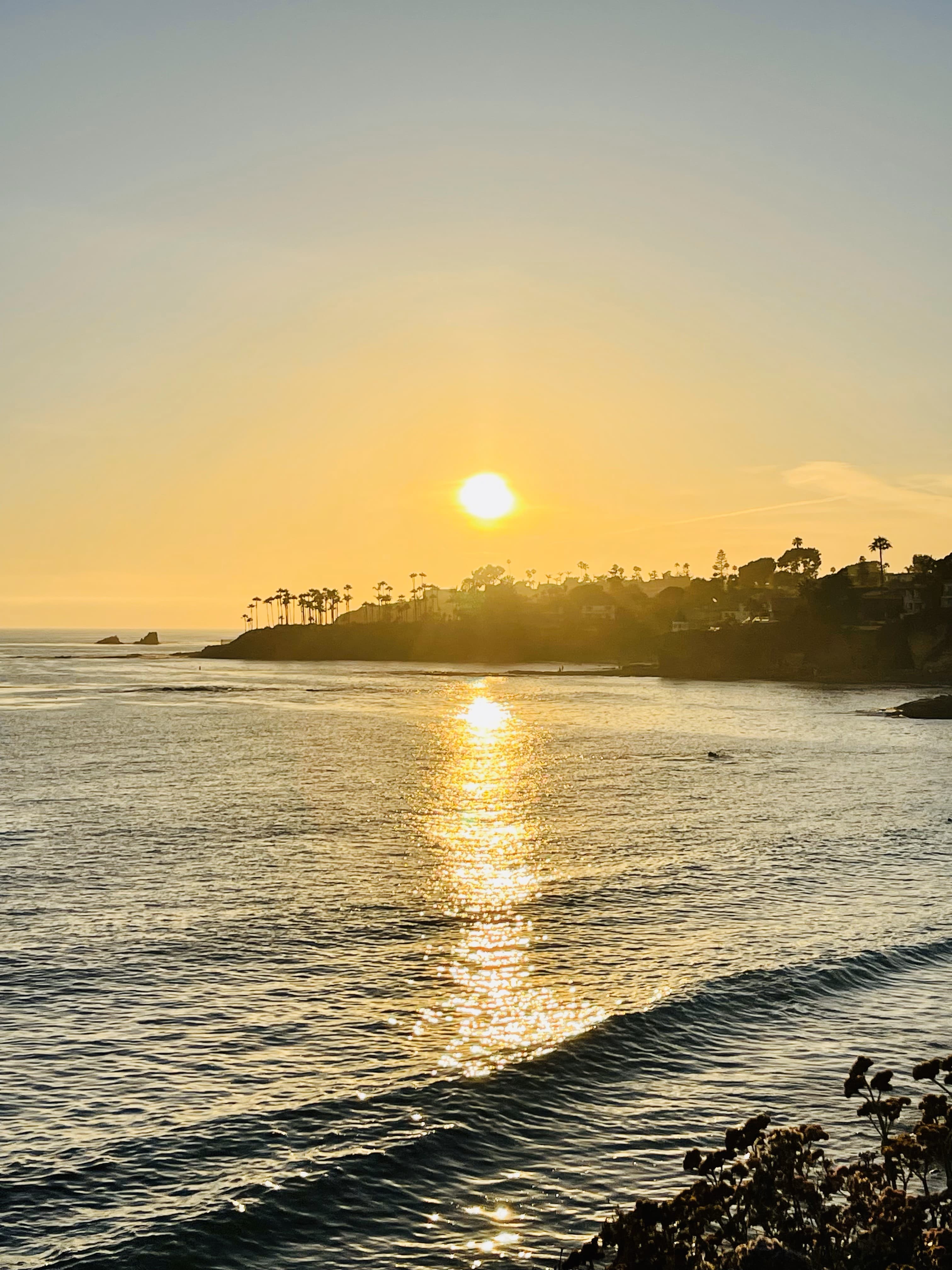 View of the sunset just above the ocean’s horizon on a clear evening