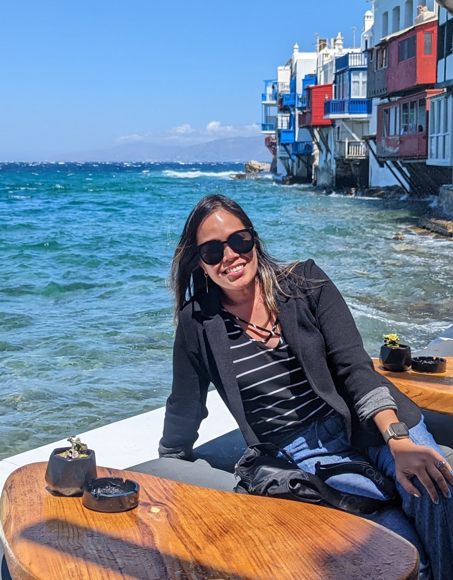 Advisor sitting at a lounge table by the sea on a sunny day