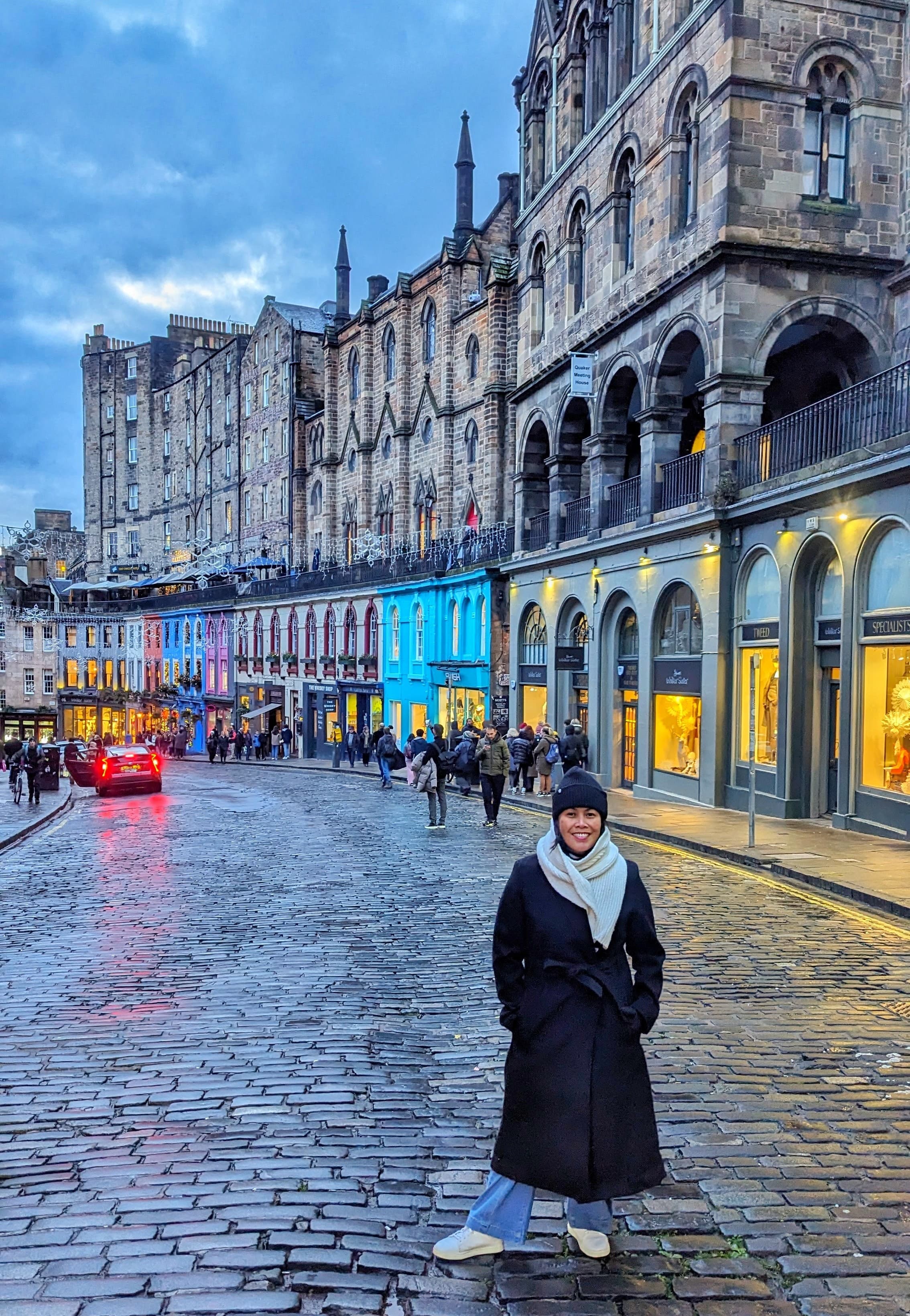 Advisor in winter clothing standing on a street in Amsterdam on a cloudy day