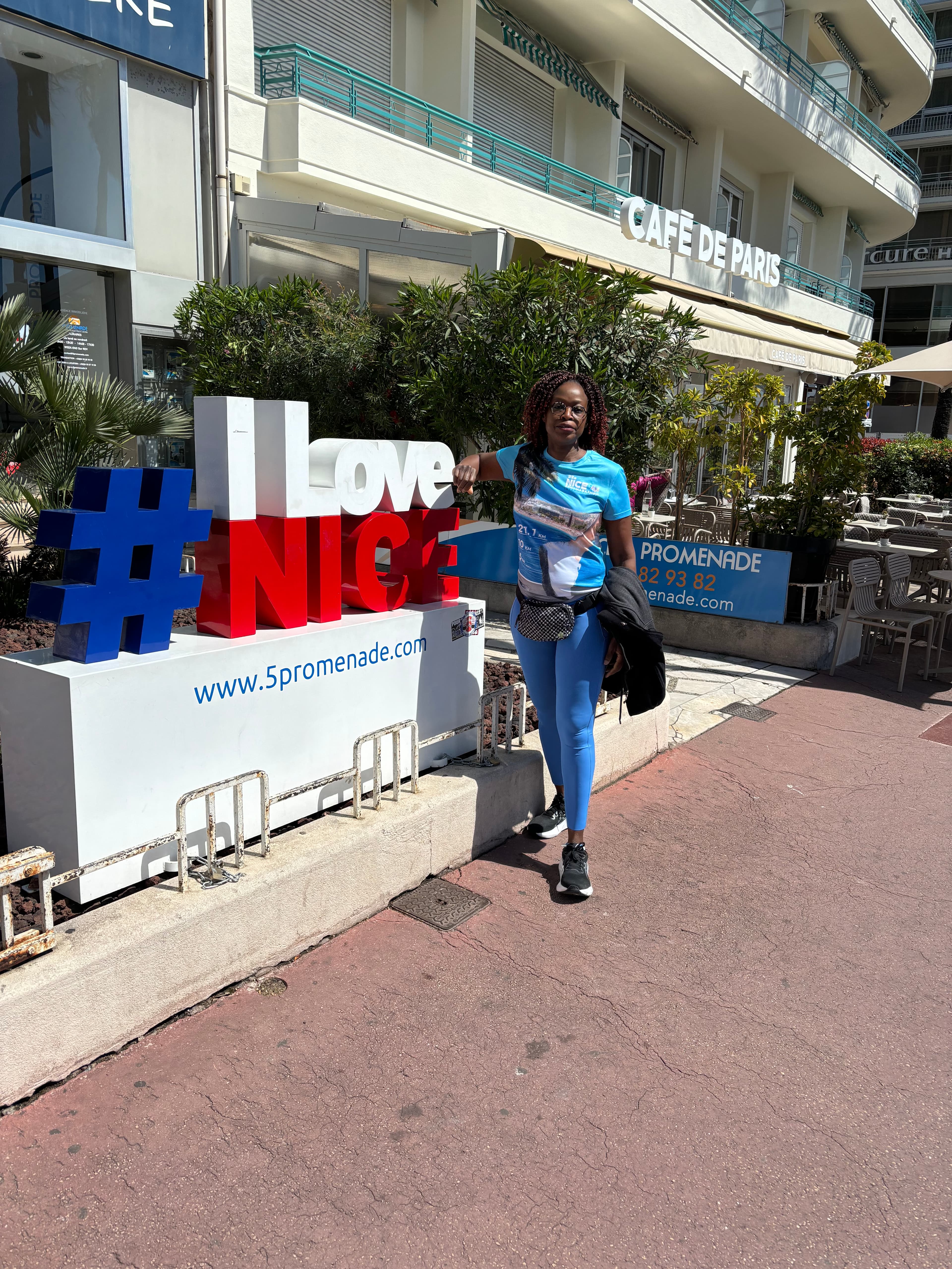 Advisor standing in front of a red, white and blue street sign