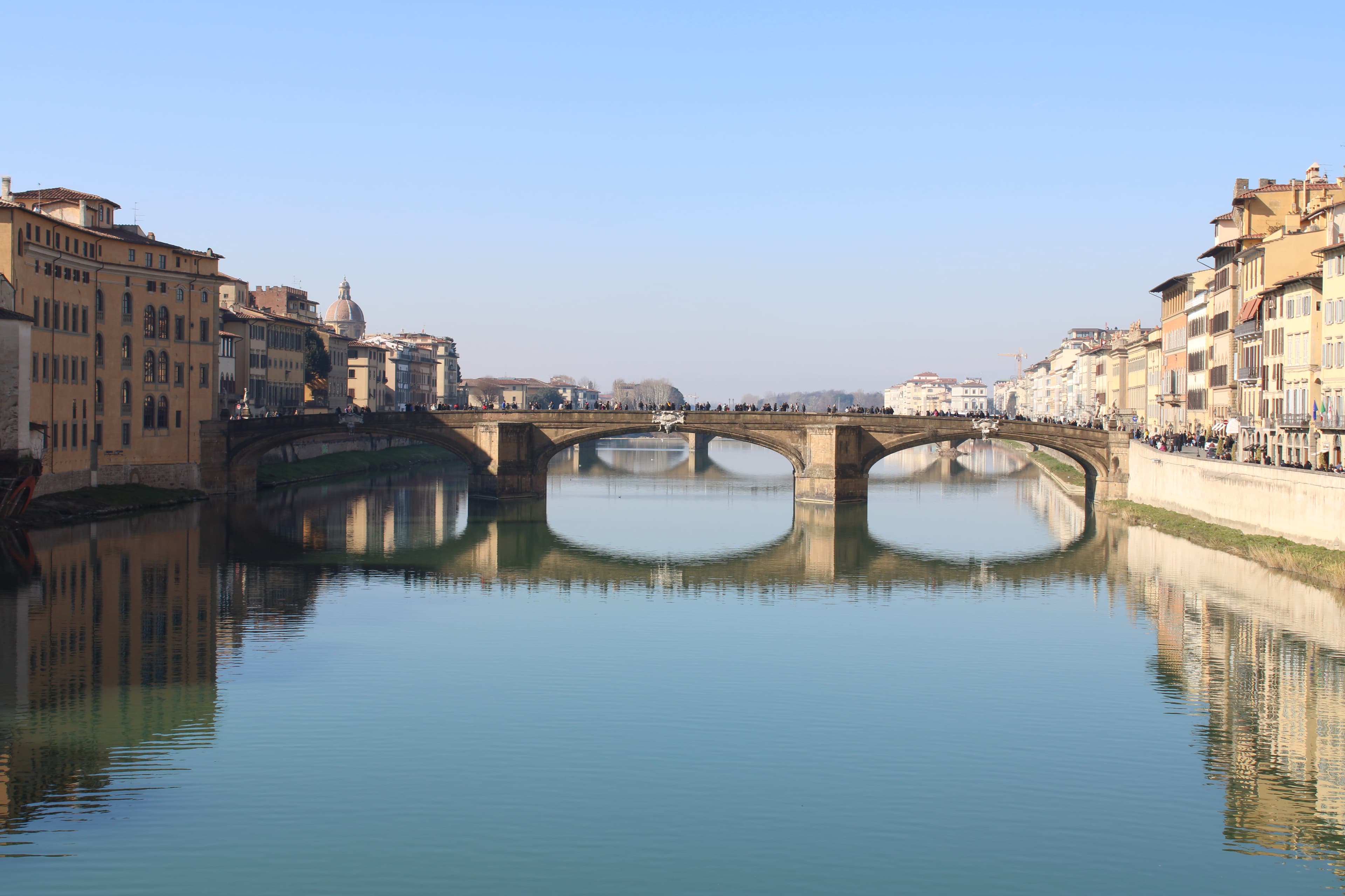 View of an old stone bridge in Florence, Italy on a clear day