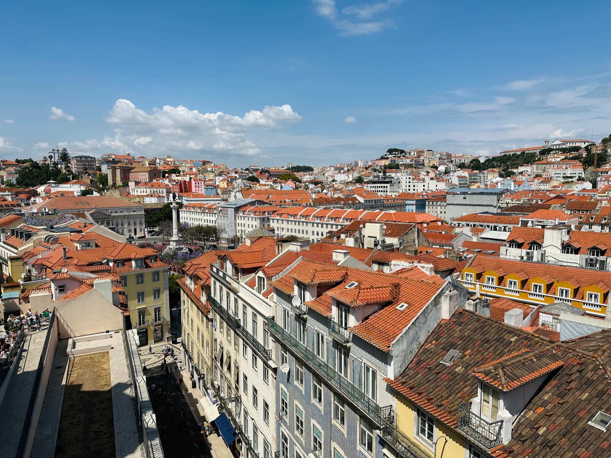 View of orange-tiled rooftops in a sunny city