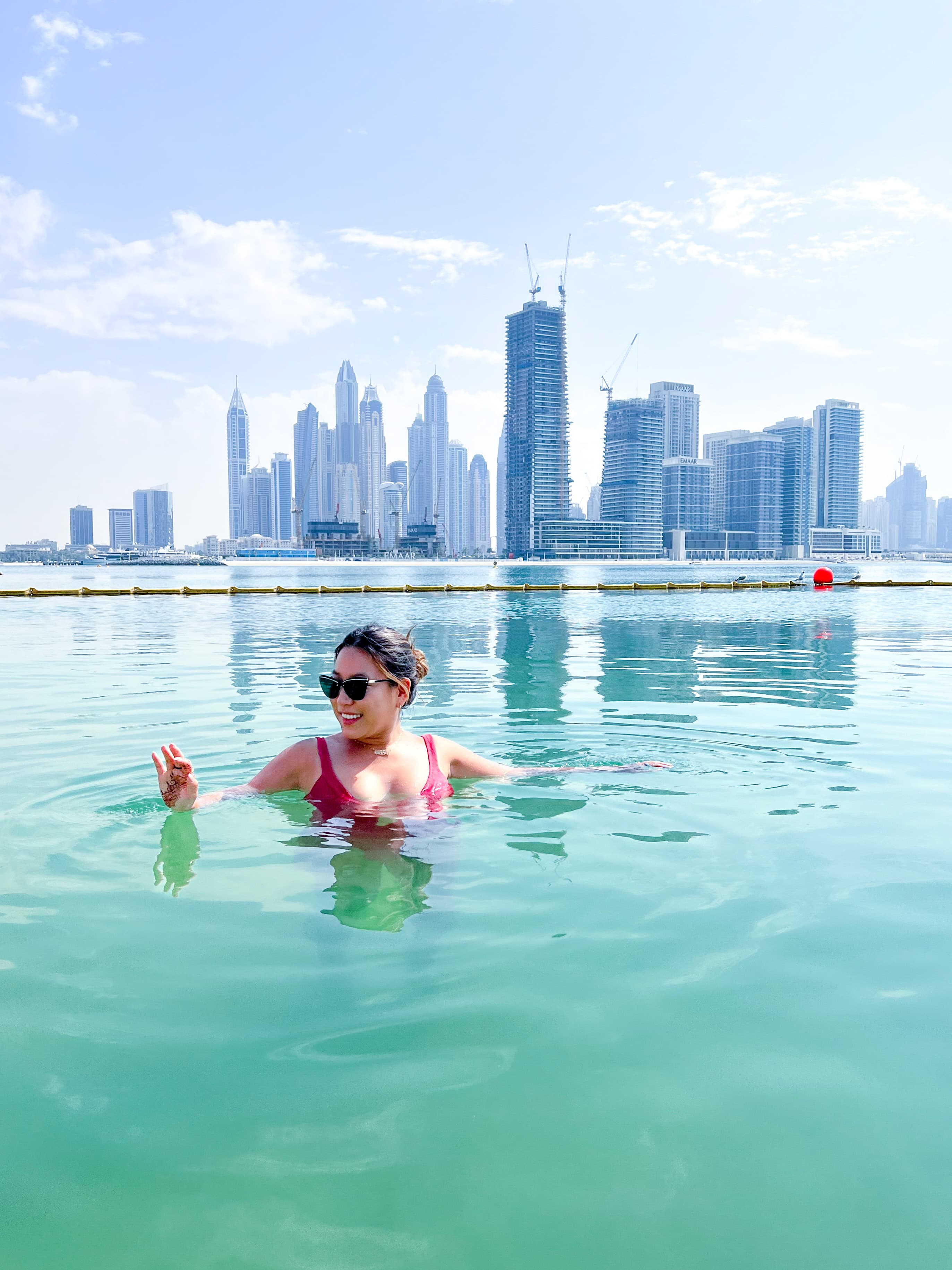 Pool with city skyline in back.