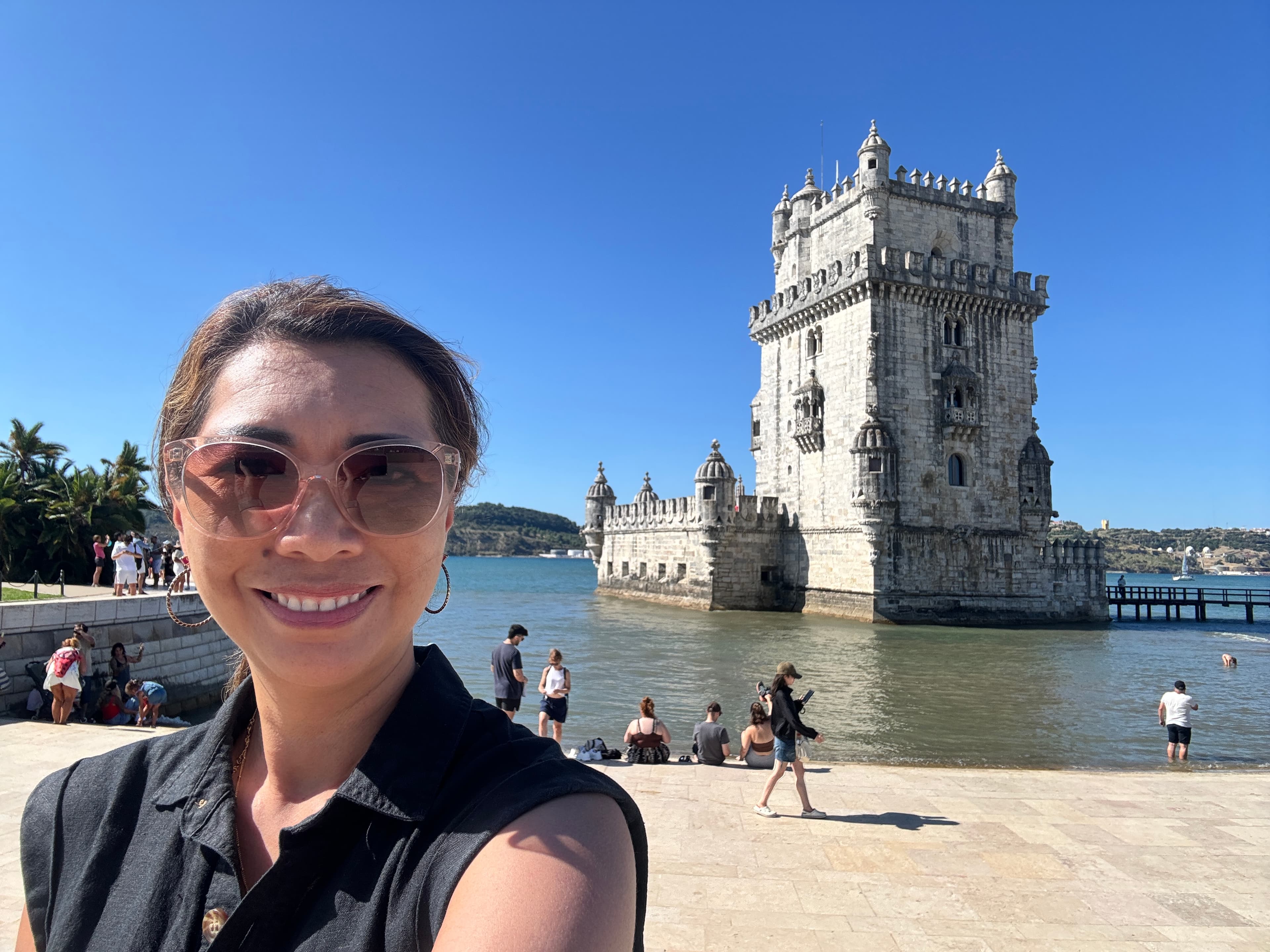 Advisor posing for an image outside with an ancient structure in the distance.