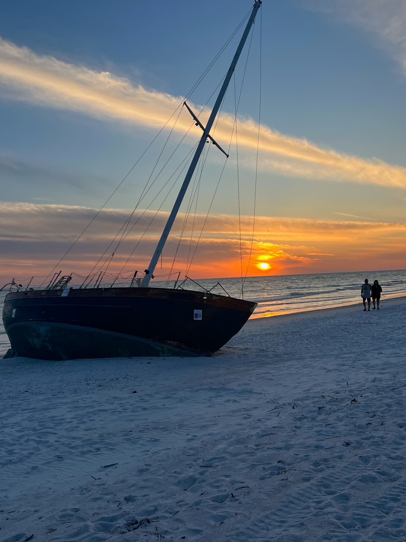 Boat on the beach at sunset.