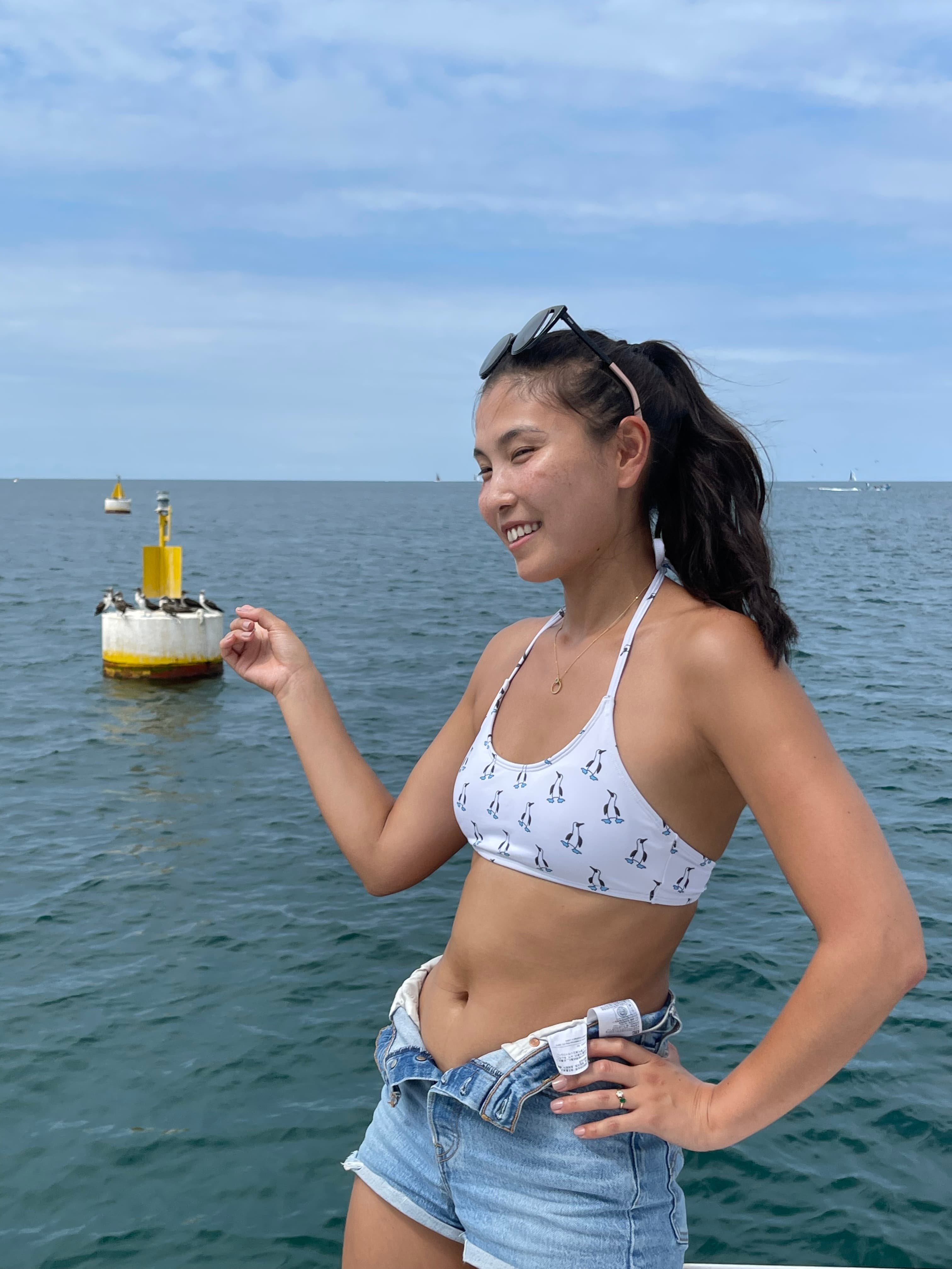 Advisor smiling by the sea on a sunny day