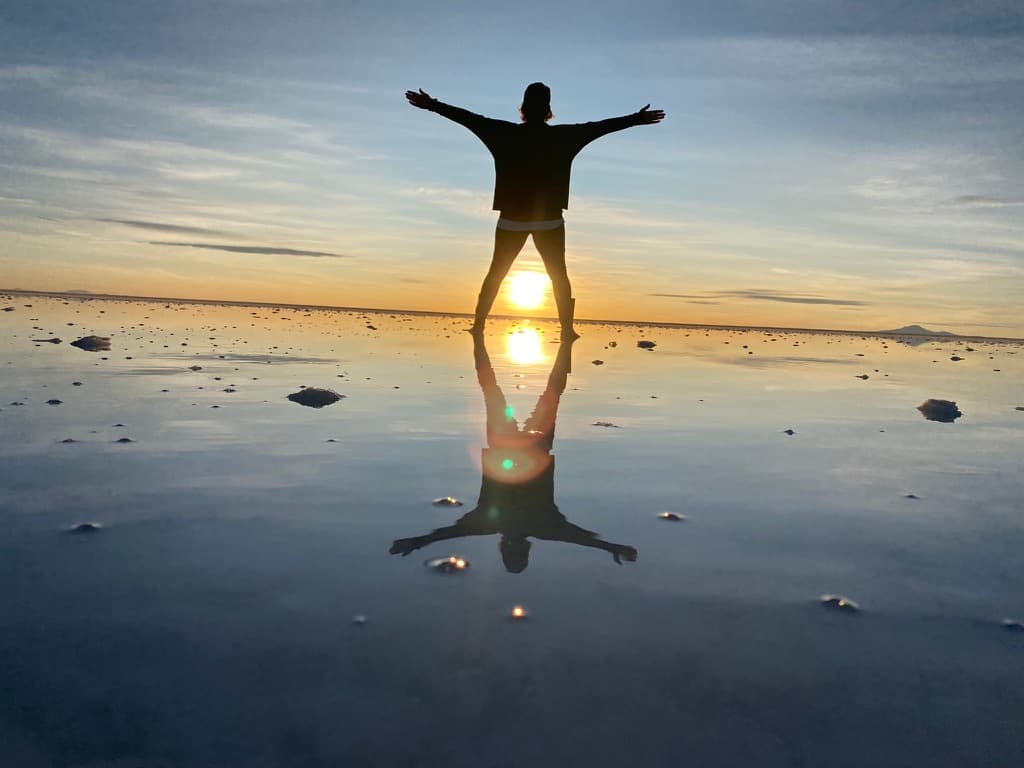 Advisor posing in nature at dusk.