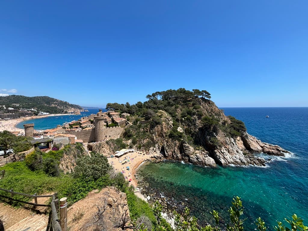 A view of the ocean and an island in the distance on a sunny day.