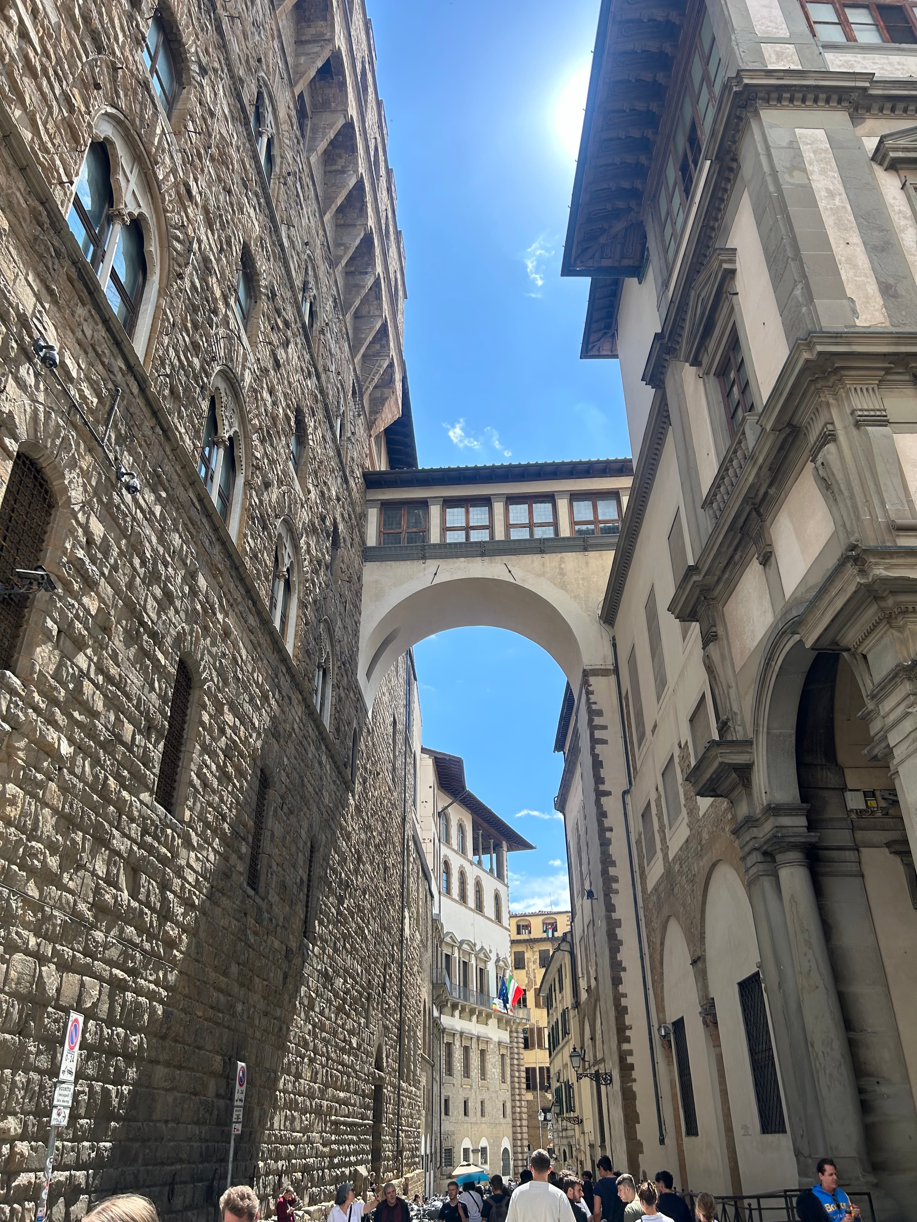 View of stone buildings during the daytime from the street.