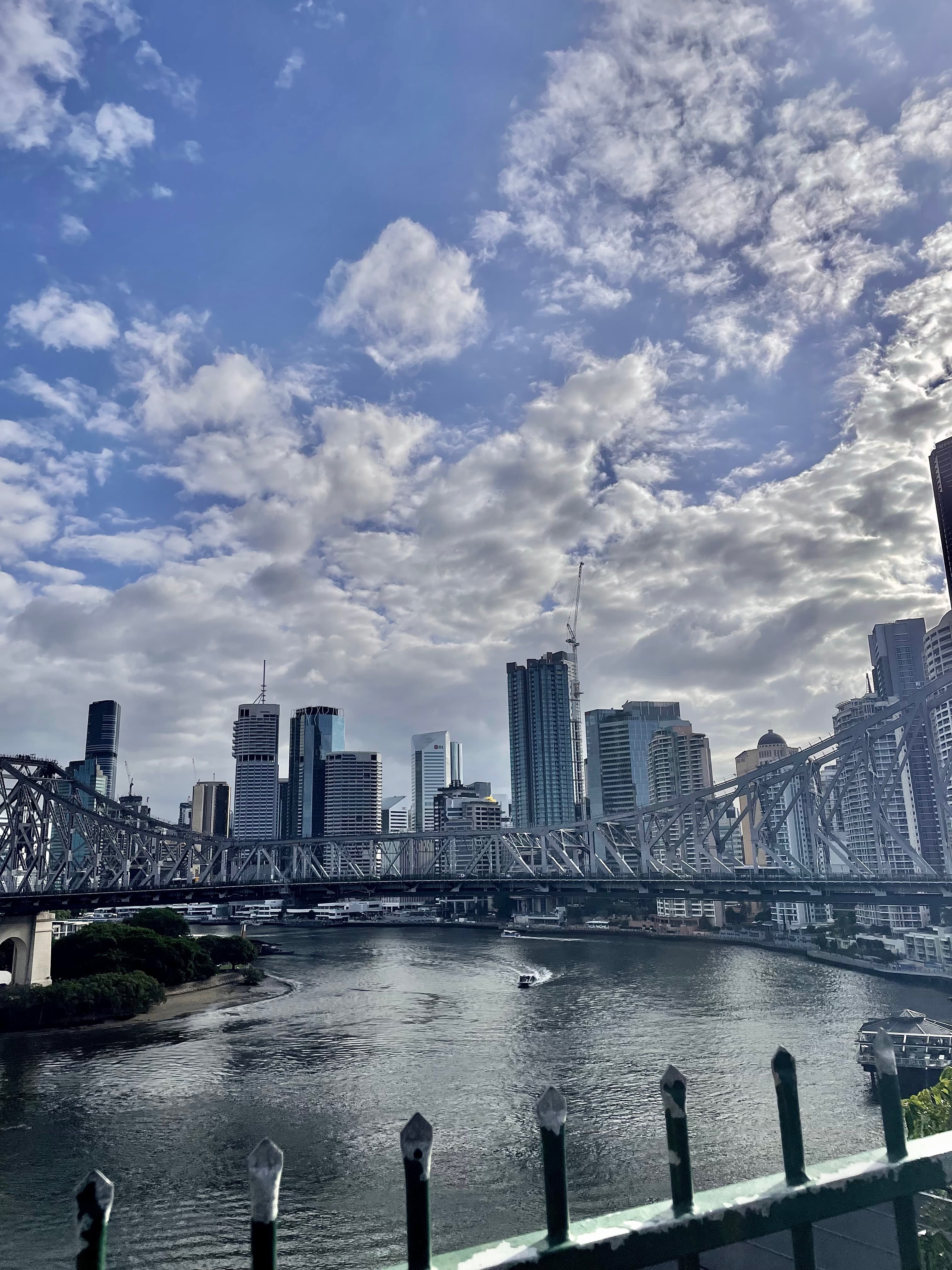 A view of the city with a water way and clouds in the distance.