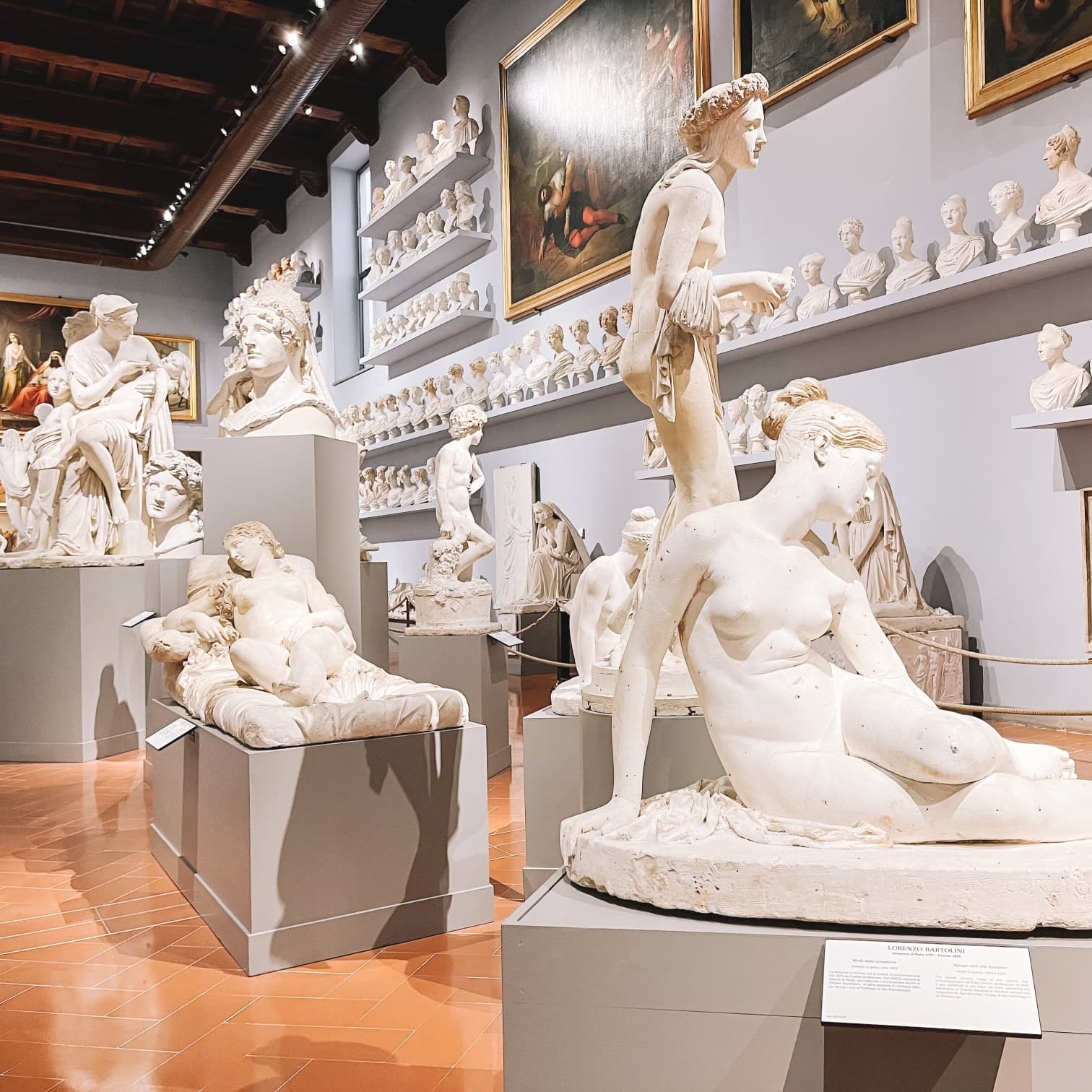 View of many white marble sculptures in a gallery in Florence, Italy