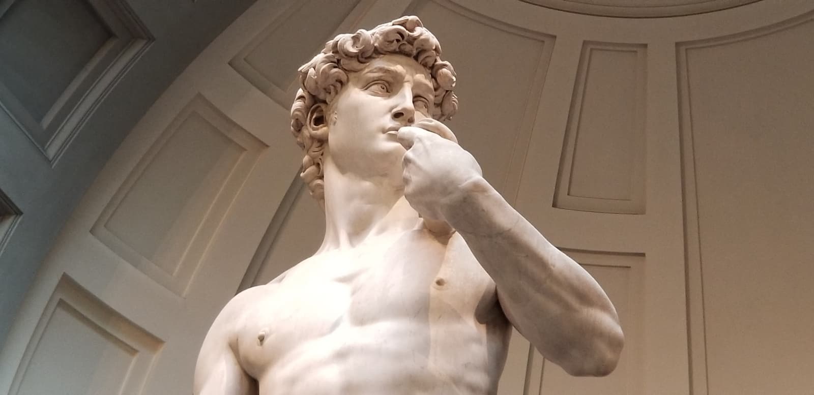Close up photo of Michelangelo’s David statue in a museum in Florence, Italy