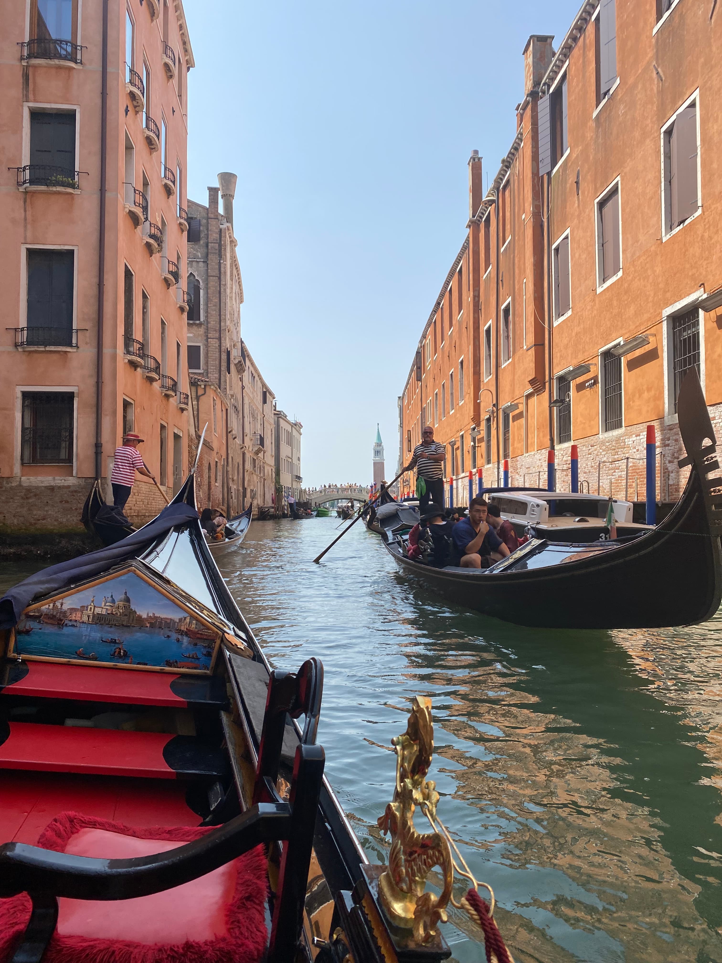 View from a gondola on a canal on a sunny day in Venice, Italy