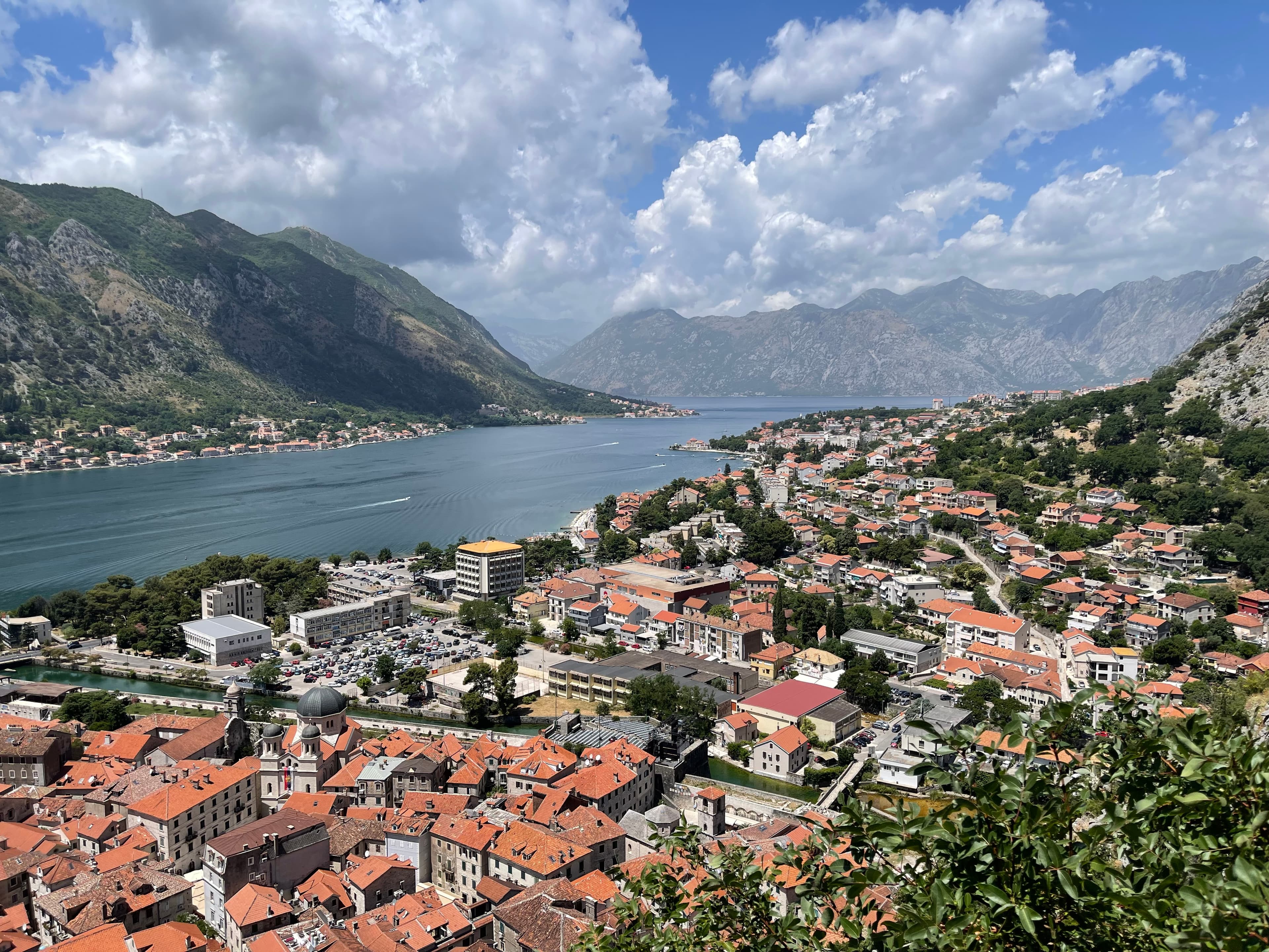 Aerial view of Kotor and the bay lined with mountains on a sunny day