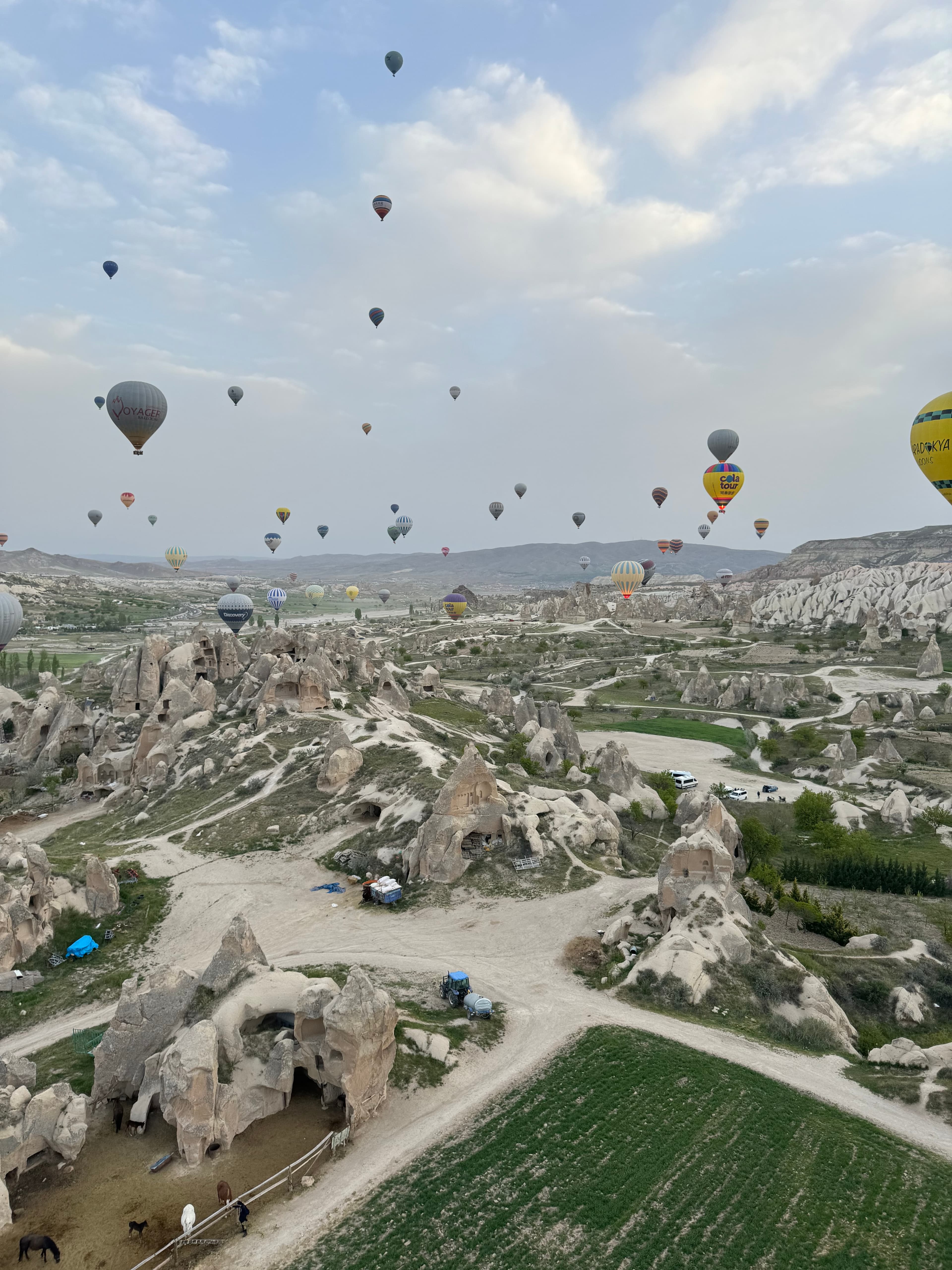 View of dozens of hot air balloons in the sky over Cappadocia, Türkiye