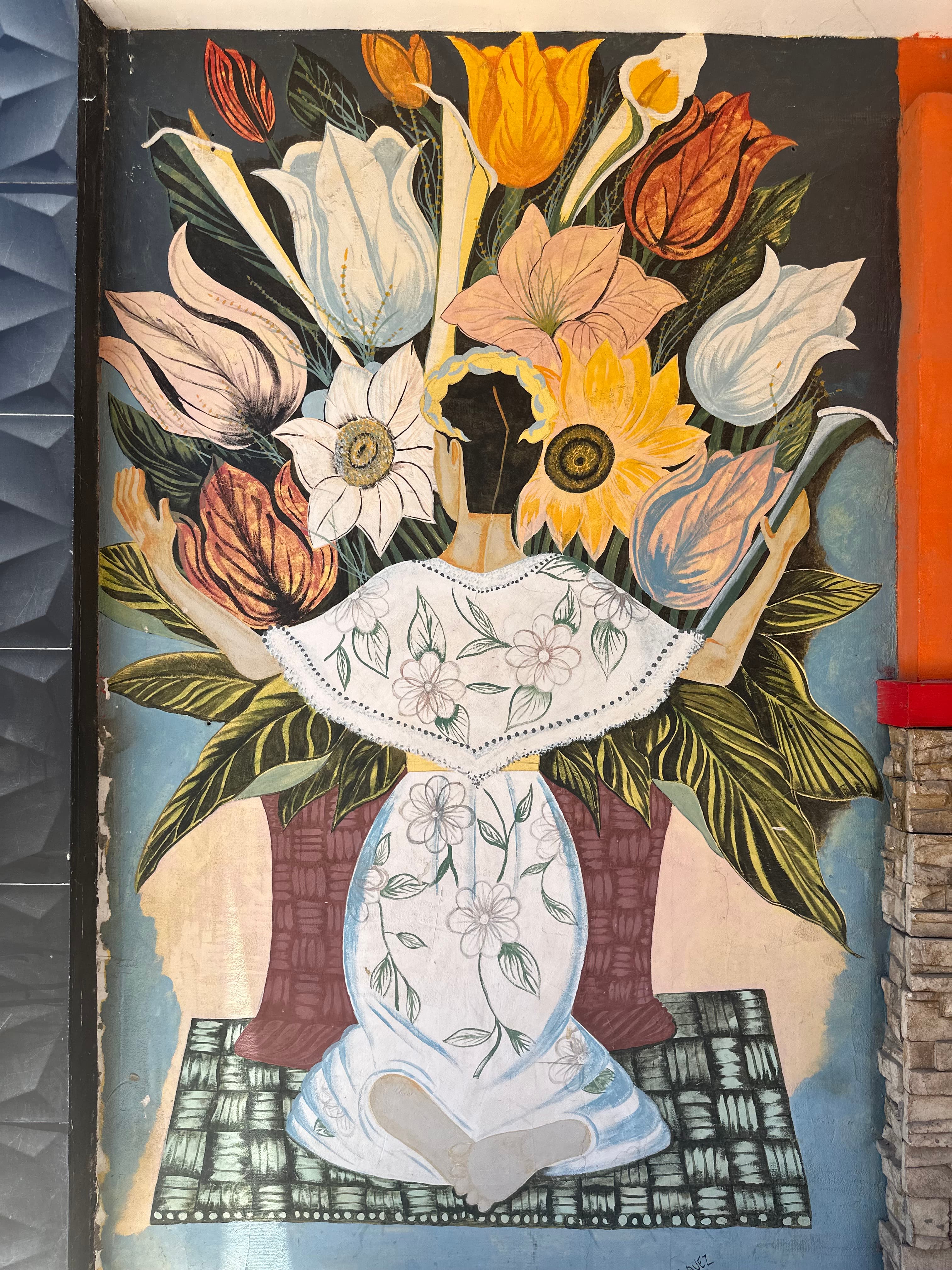 Image of a painting depicting a woman in a white dress kneeling before a large vase of flowers