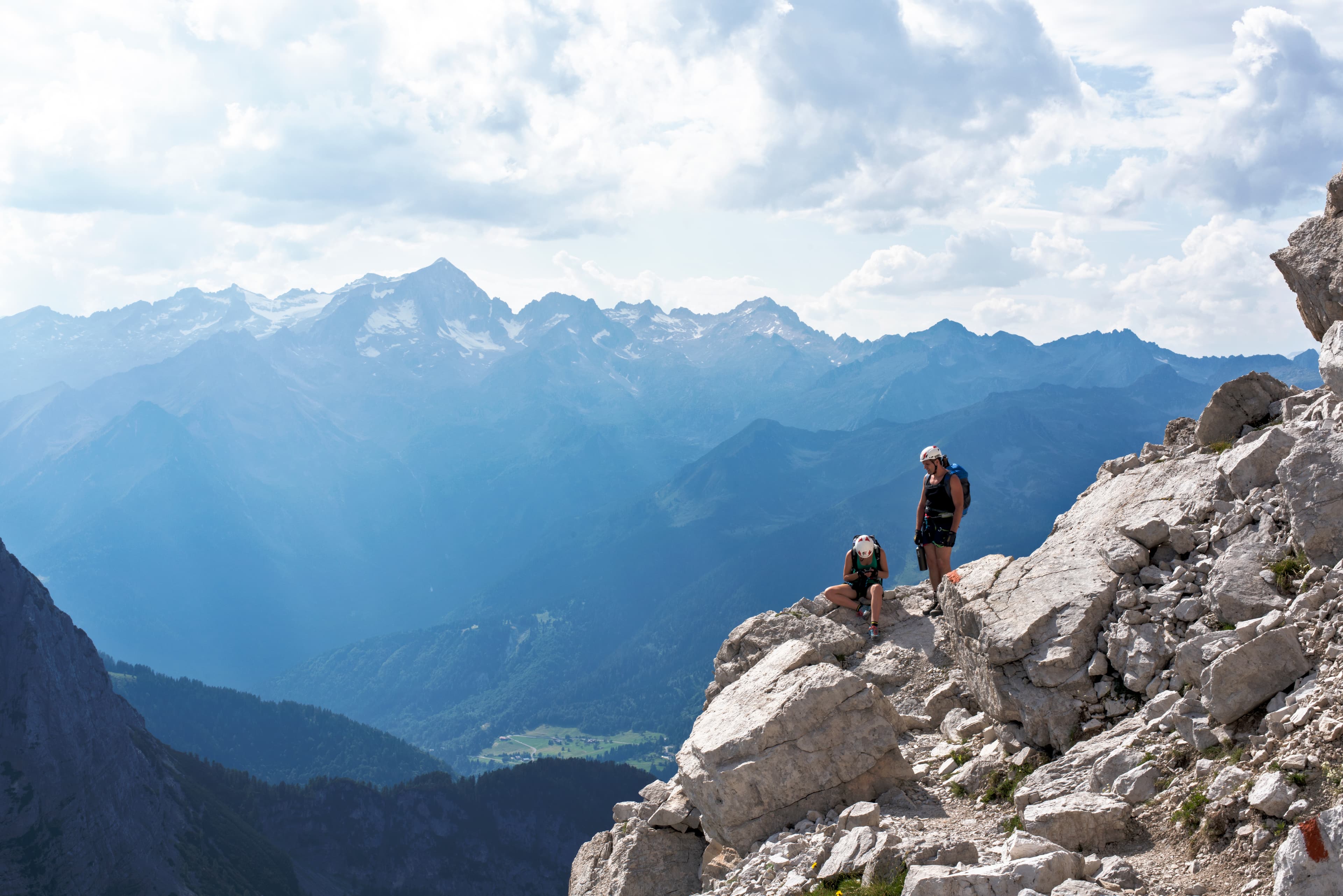 A view of the advisor posing on a mountain side after a hike.