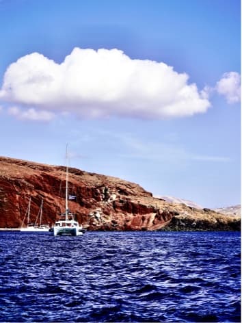 View from a boat of a rocky coastline and the sea on a sunny day