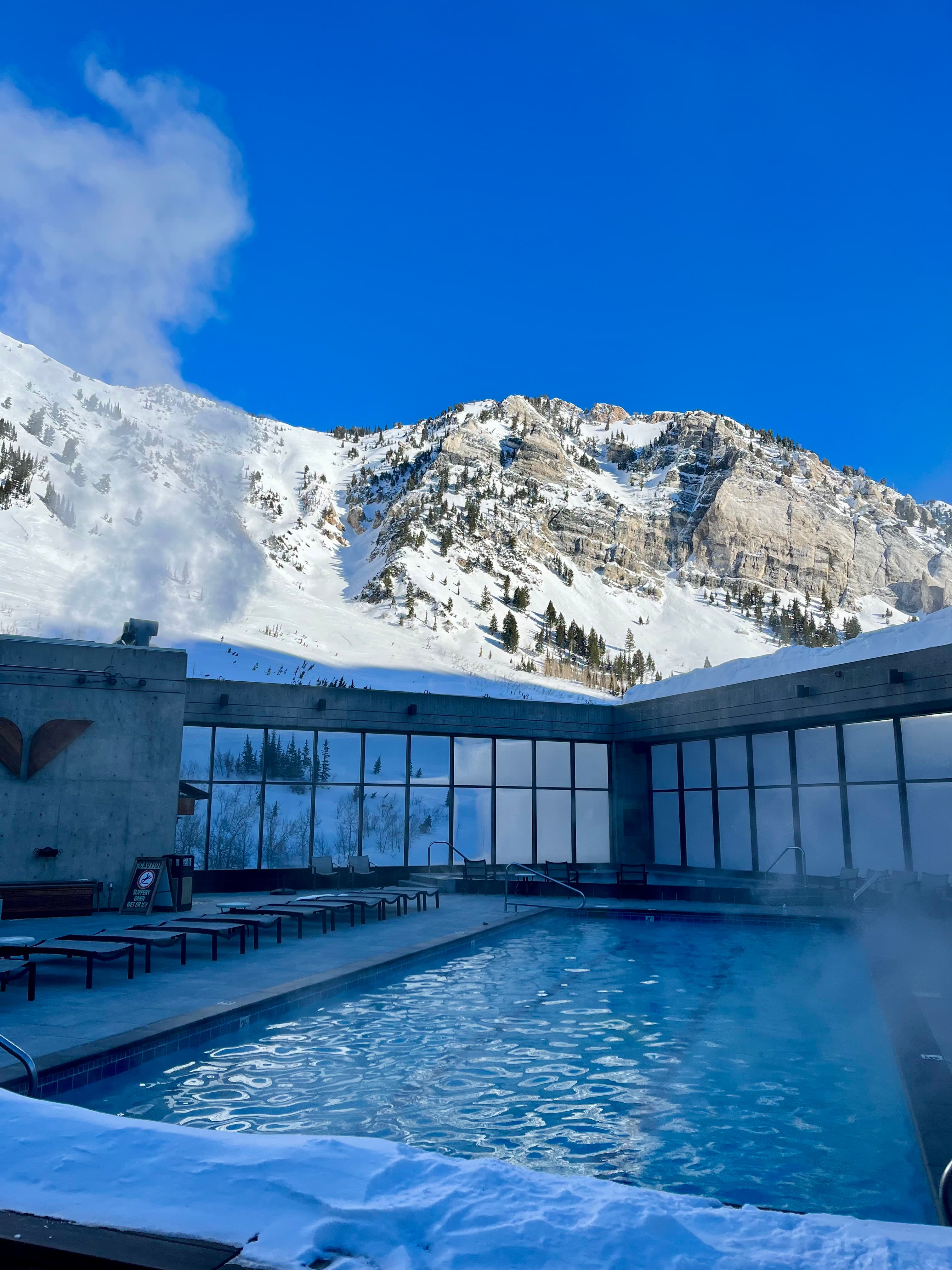 View of a resort pool in the snowy mountains on a clear day