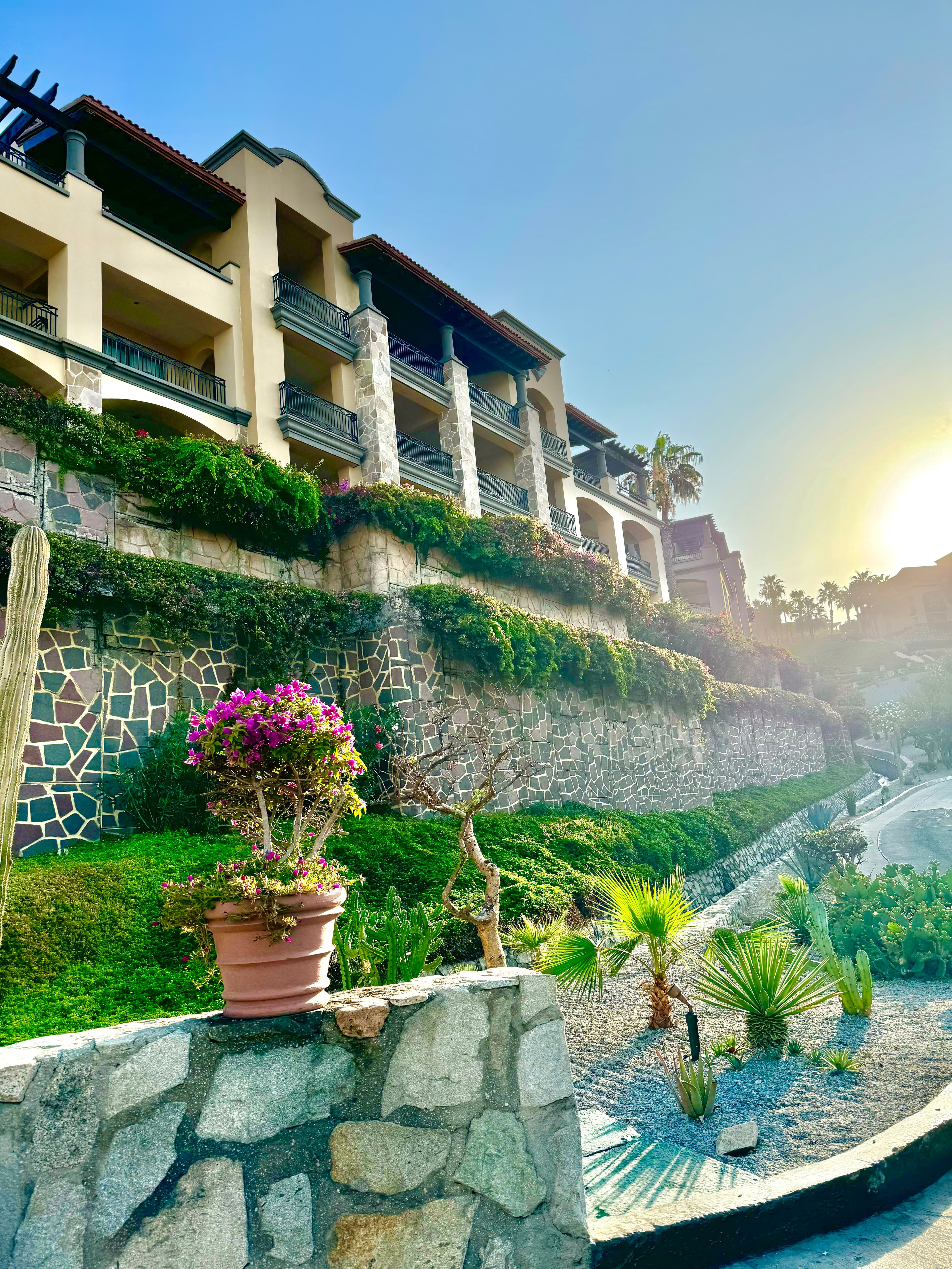 Sunny view of the side of a resort building with columns and balconies