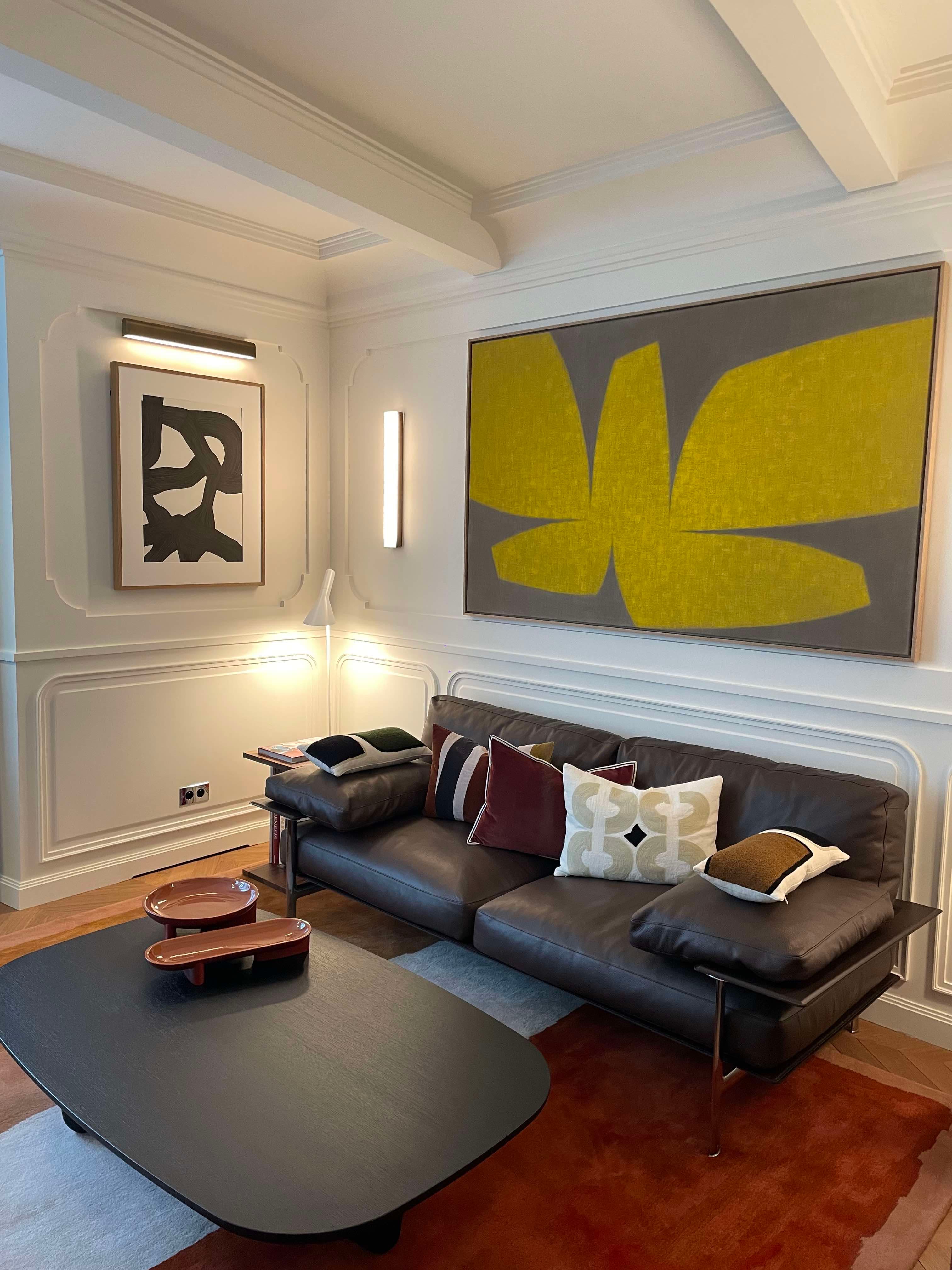 Interior view of a hotel room with leather sofa and modern art on the walls