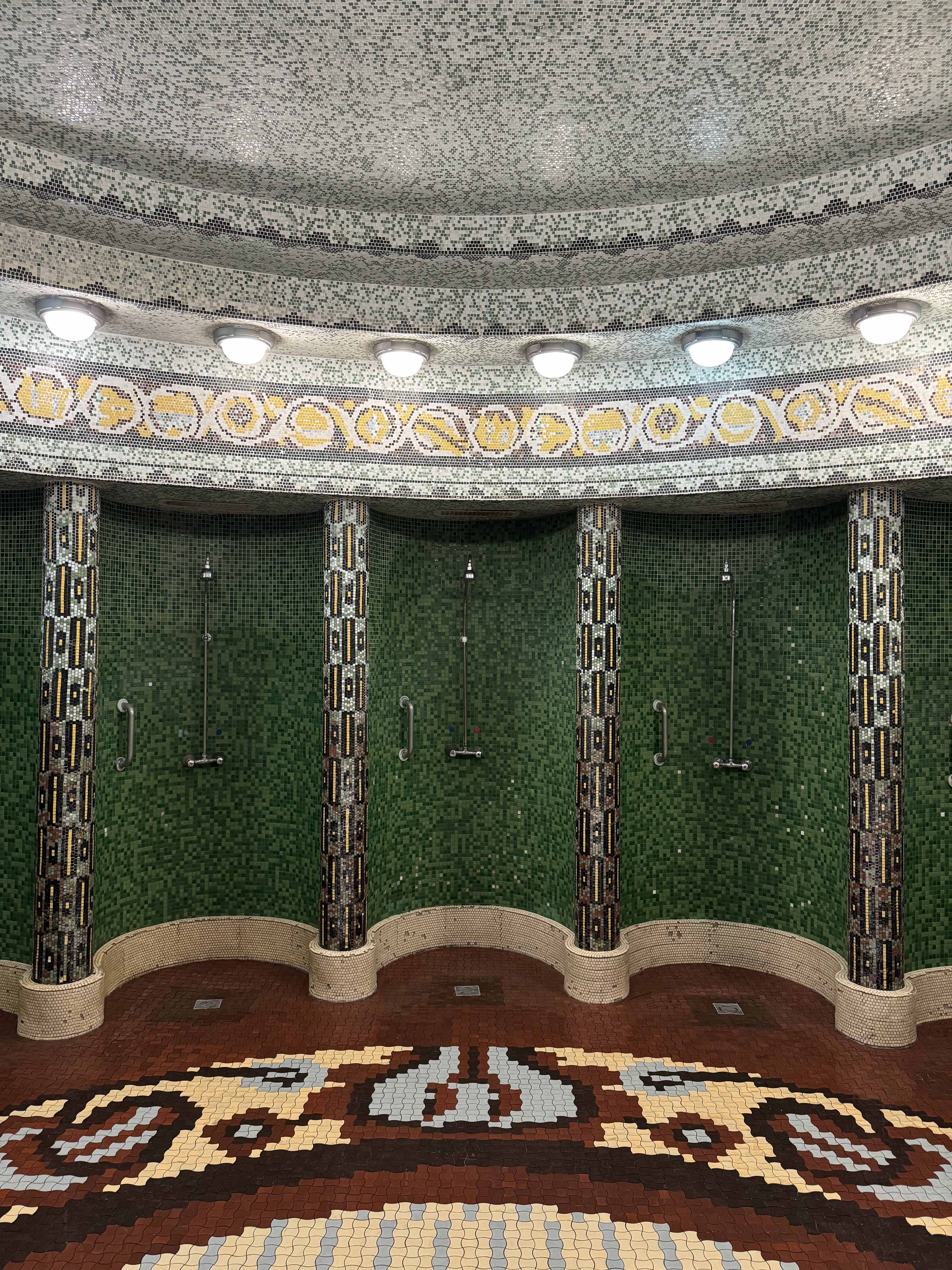 Interior view of a bathhouse in Budapest with green and red tiled walls