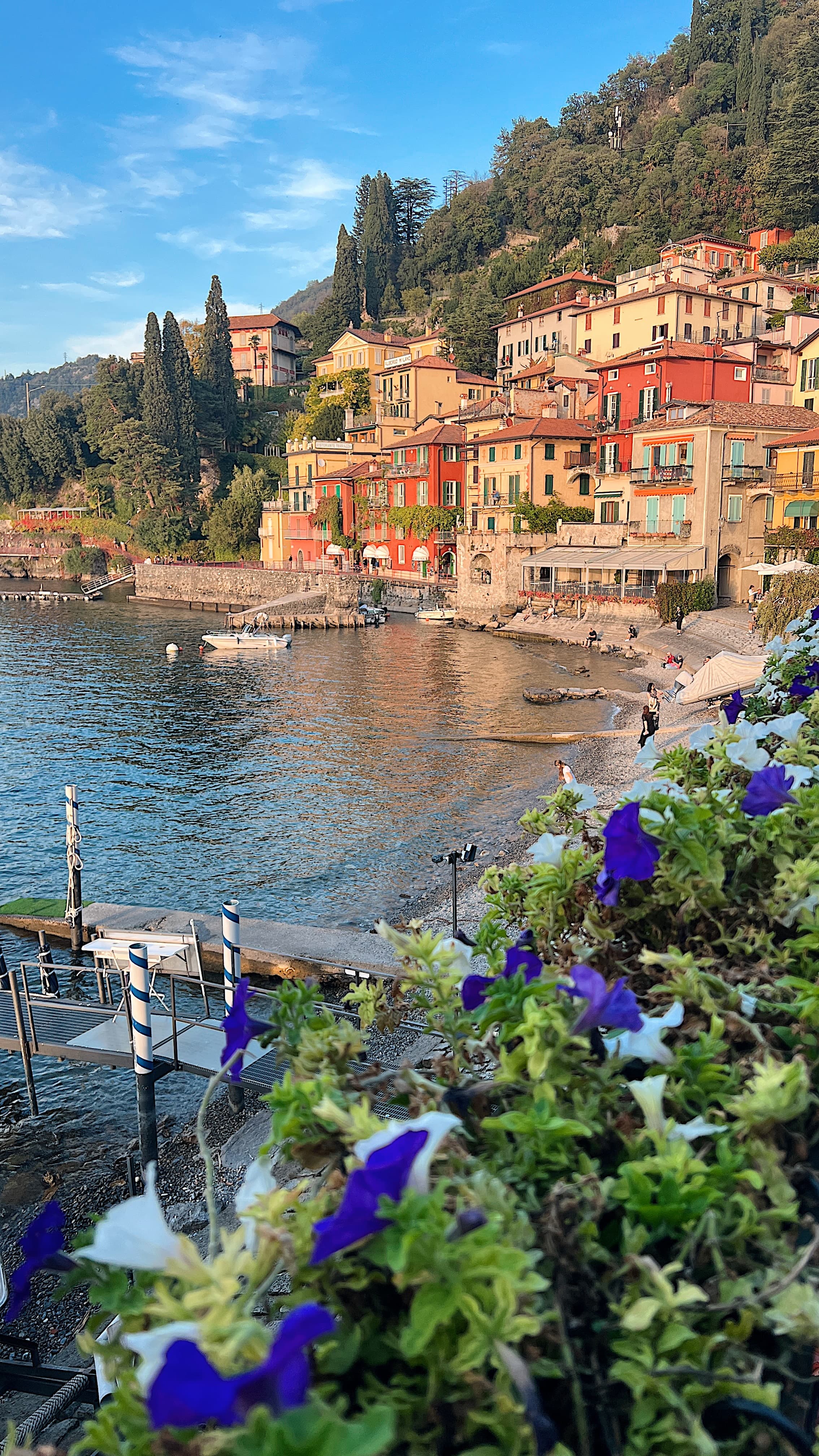 View of a beautiful coastal town painted pastel colors rising above a small bay