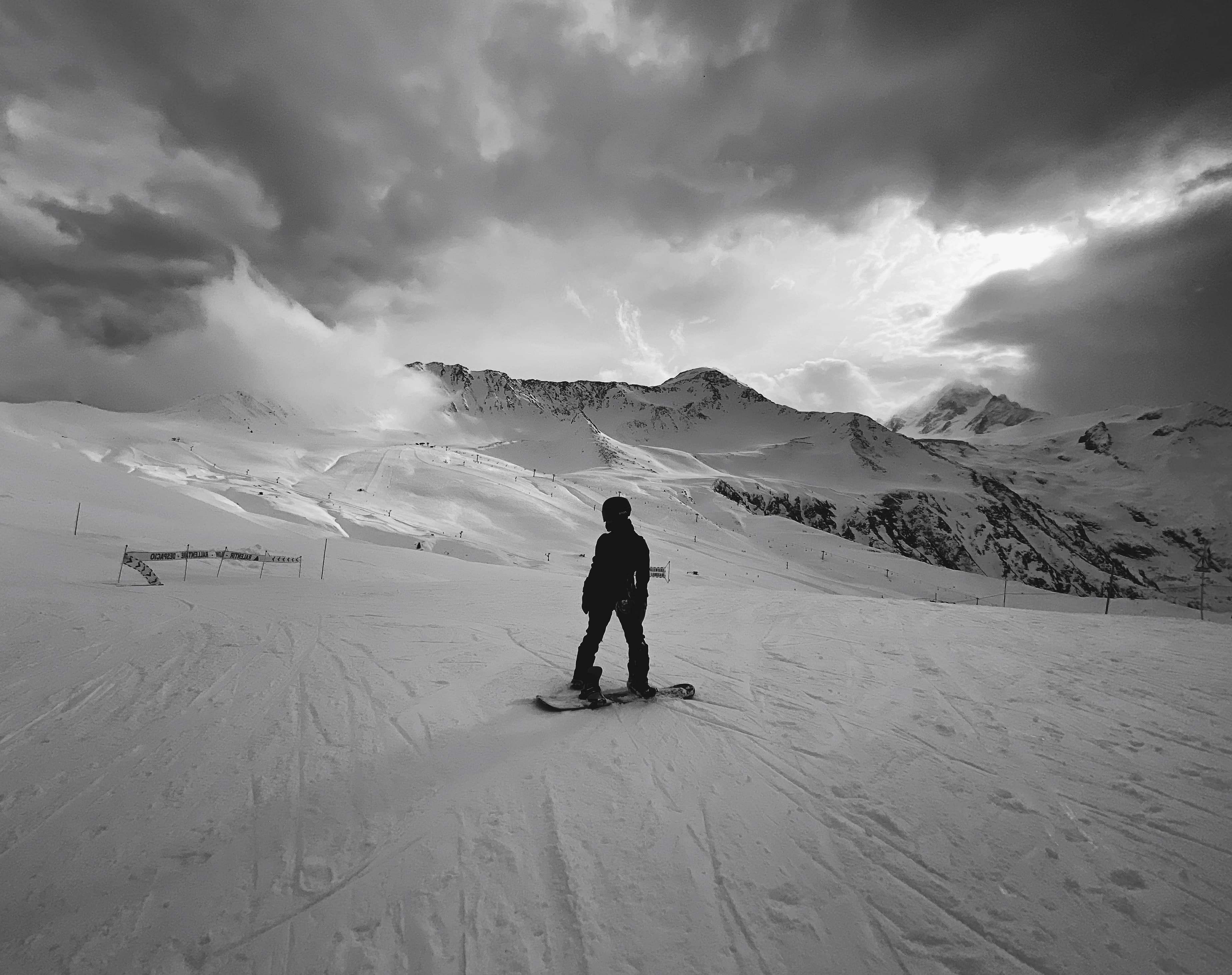 Advisor snowboarding on a cloudy day.
