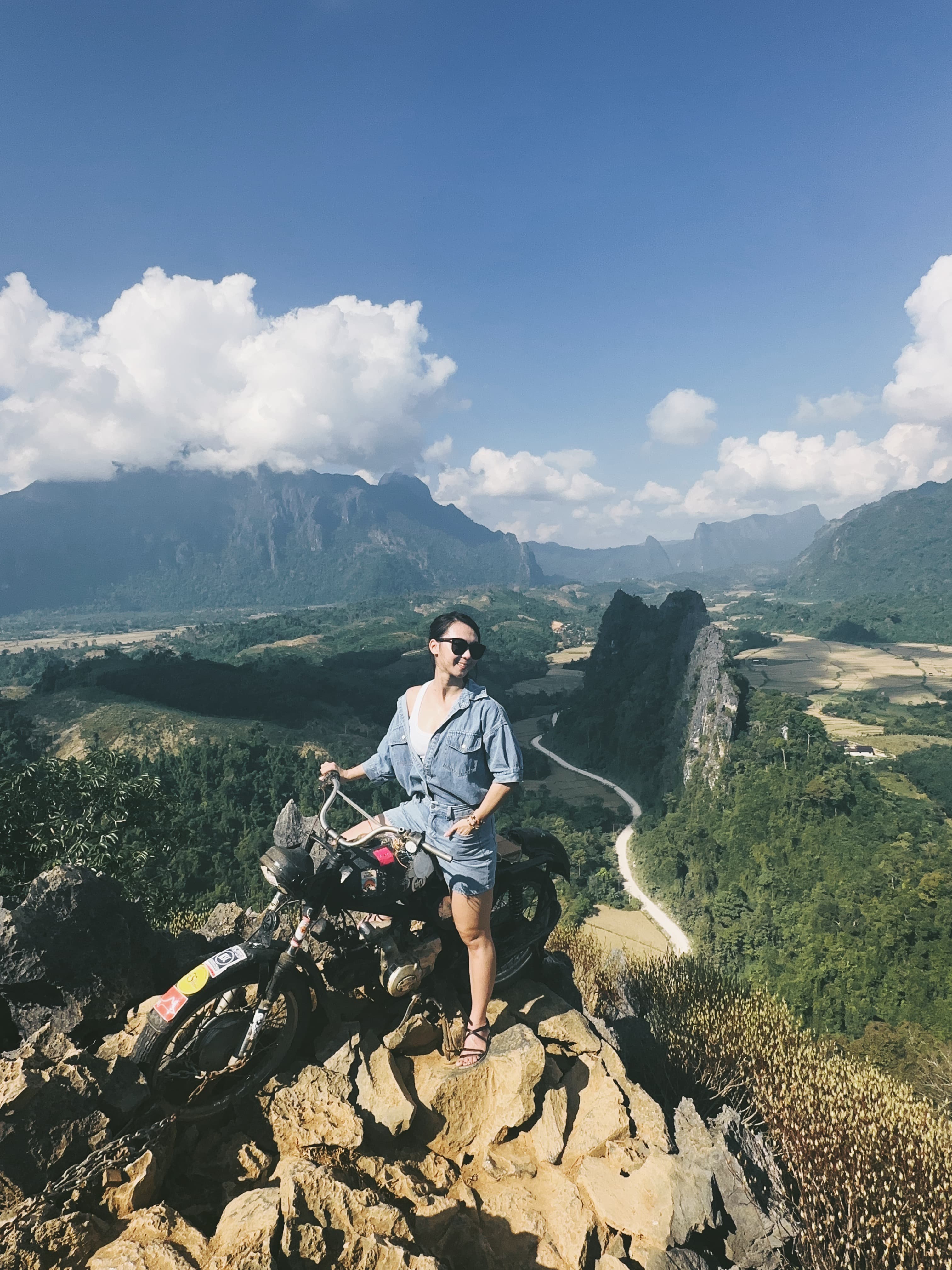 Advisor posing at the top of a mountain range on a sunny day.