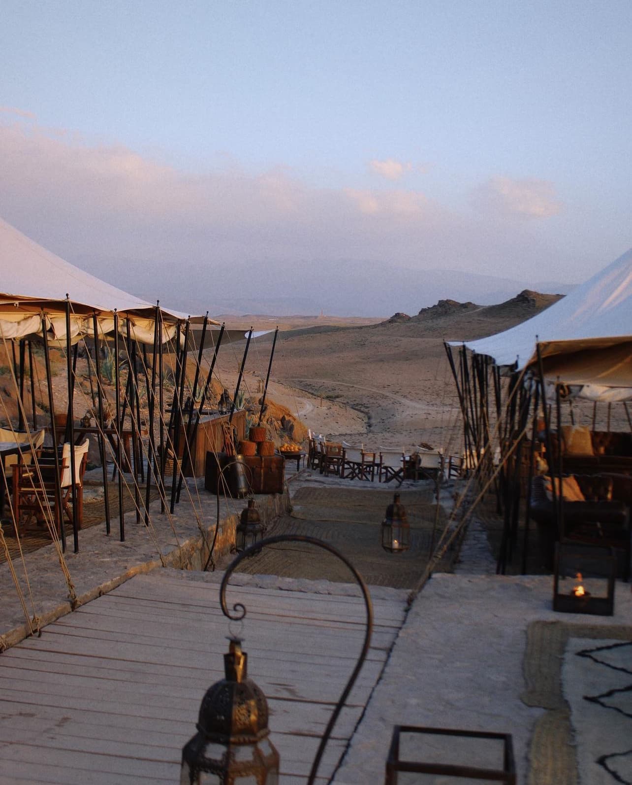 View of a patio area with covered seating at dusk in a remote area
