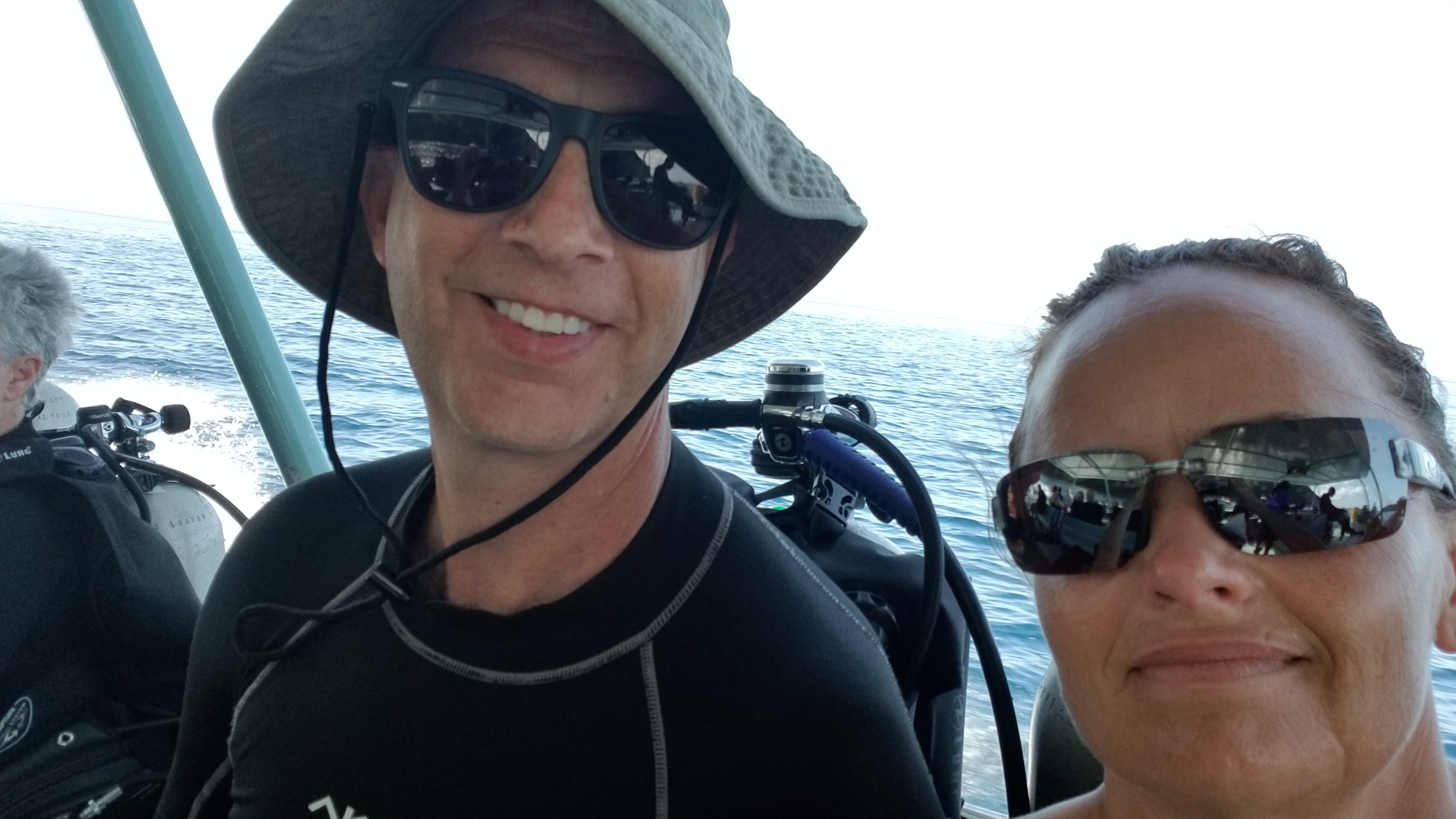 Advisor and a woman both in sunglasses taking a selfie on a boat during the day